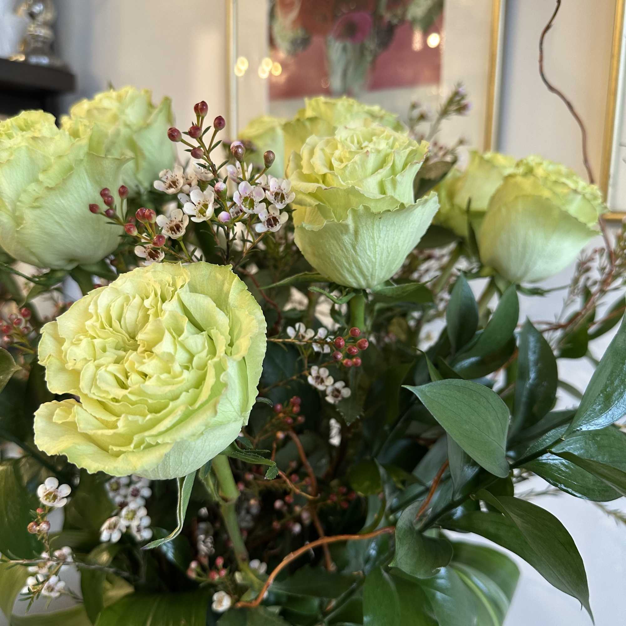 these classic arrangements, accented with seasonal foliage, are available in three stunning