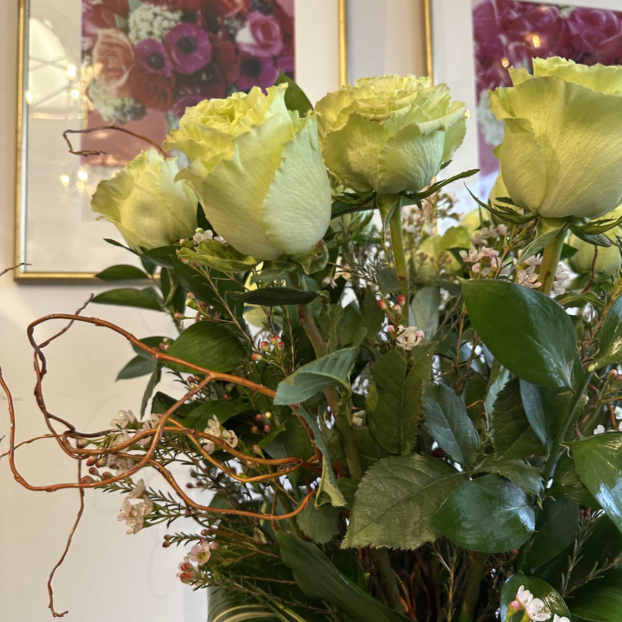 these classic arrangements, accented with seasonal foliage, are available in three stunning