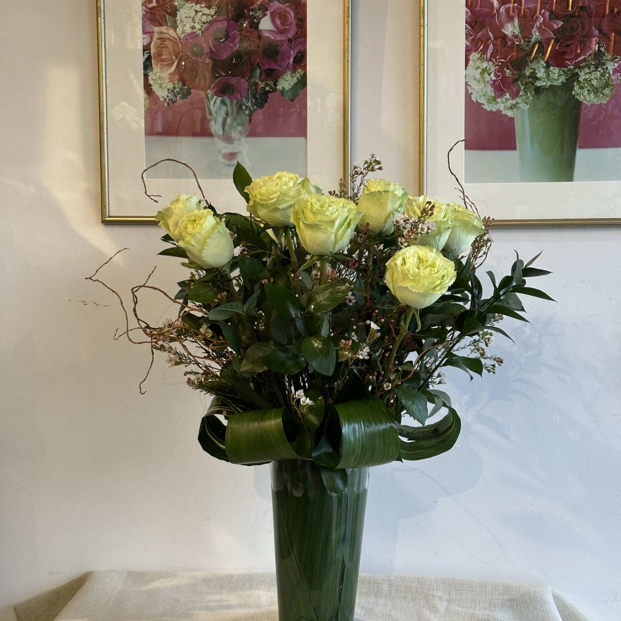 these classic arrangements, accented with seasonal foliage, are available in three stunning