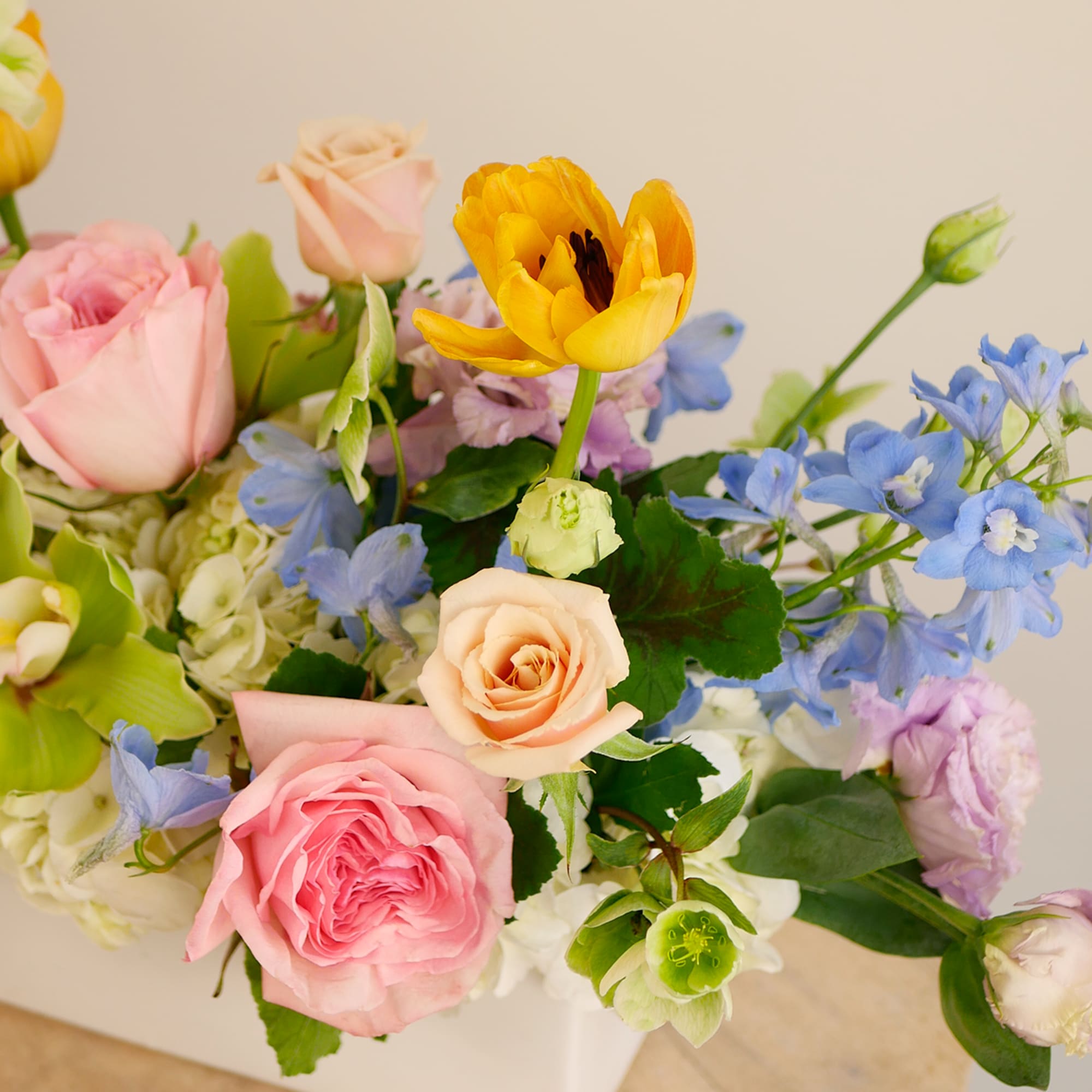 Bursting with spring color, this seasonal centerpiece features a cheerful mix of