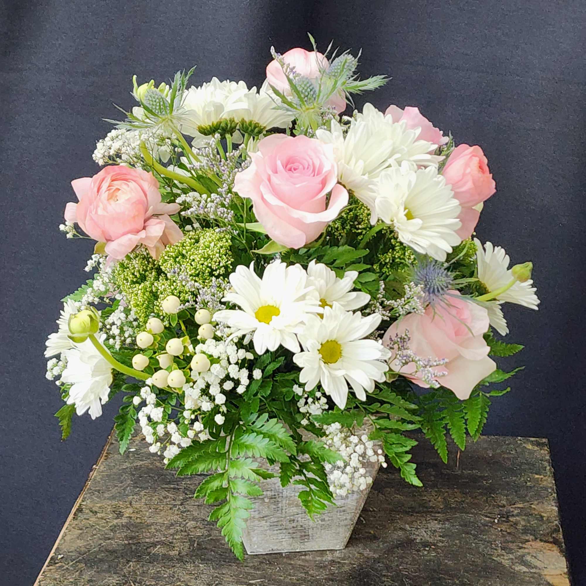 Soft and femine white and pink mix of seasonal flowers in a