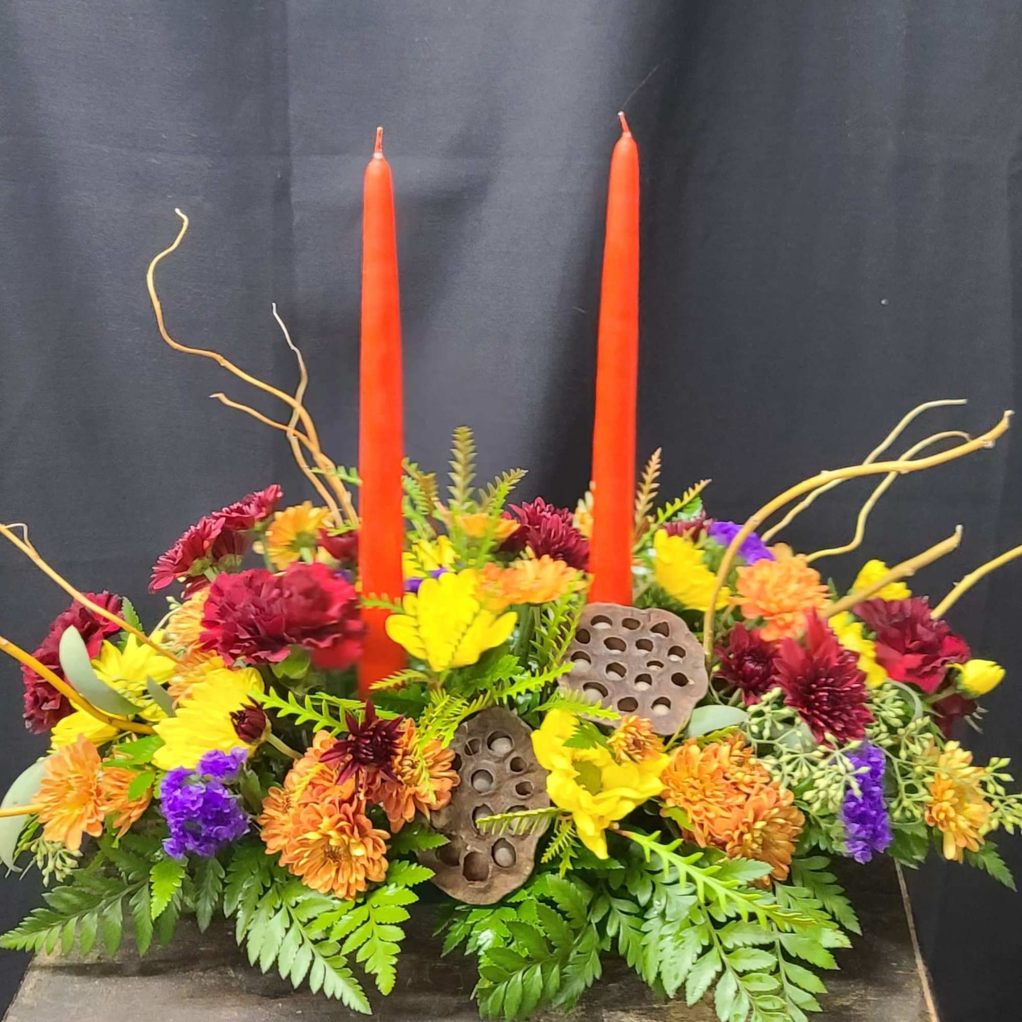 Fall colored centerpiece with natural accents and twin bittersweet colored candles. Fall