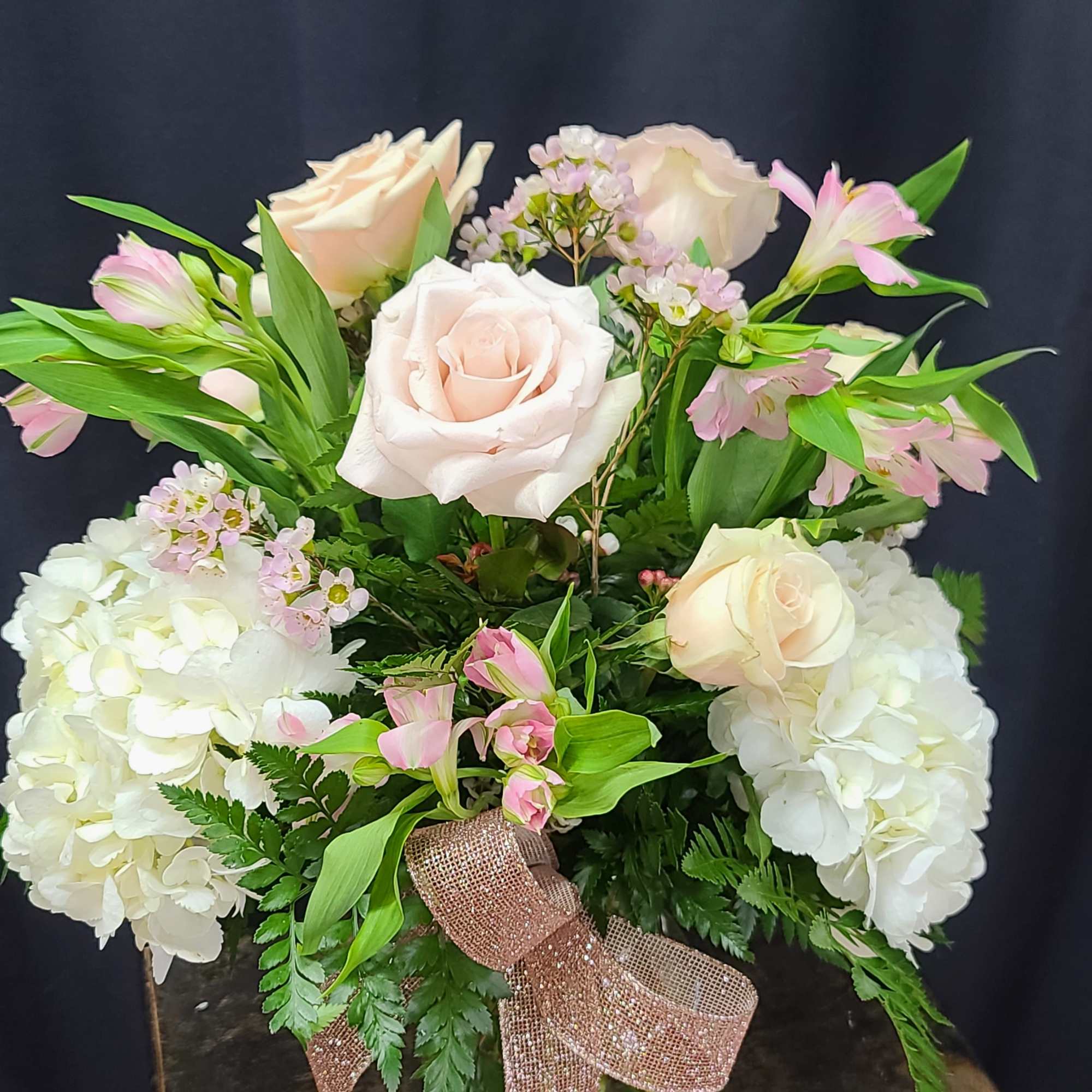 Gorgeous blush Roses, alstromaria, hydrangea, and wax flower are a beautiful way