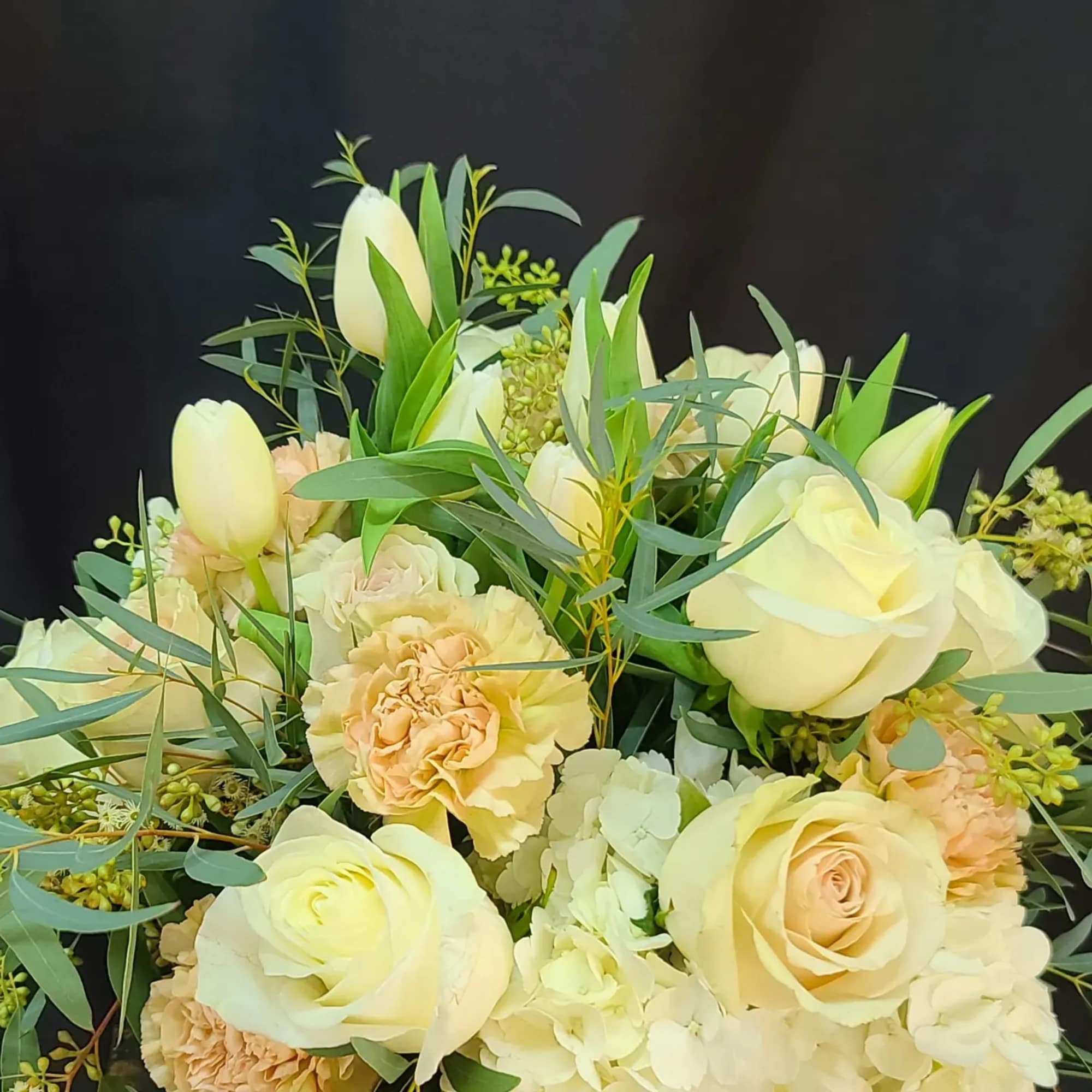 Willow twigs in the vase accent and support the lush hydrangeas, blush