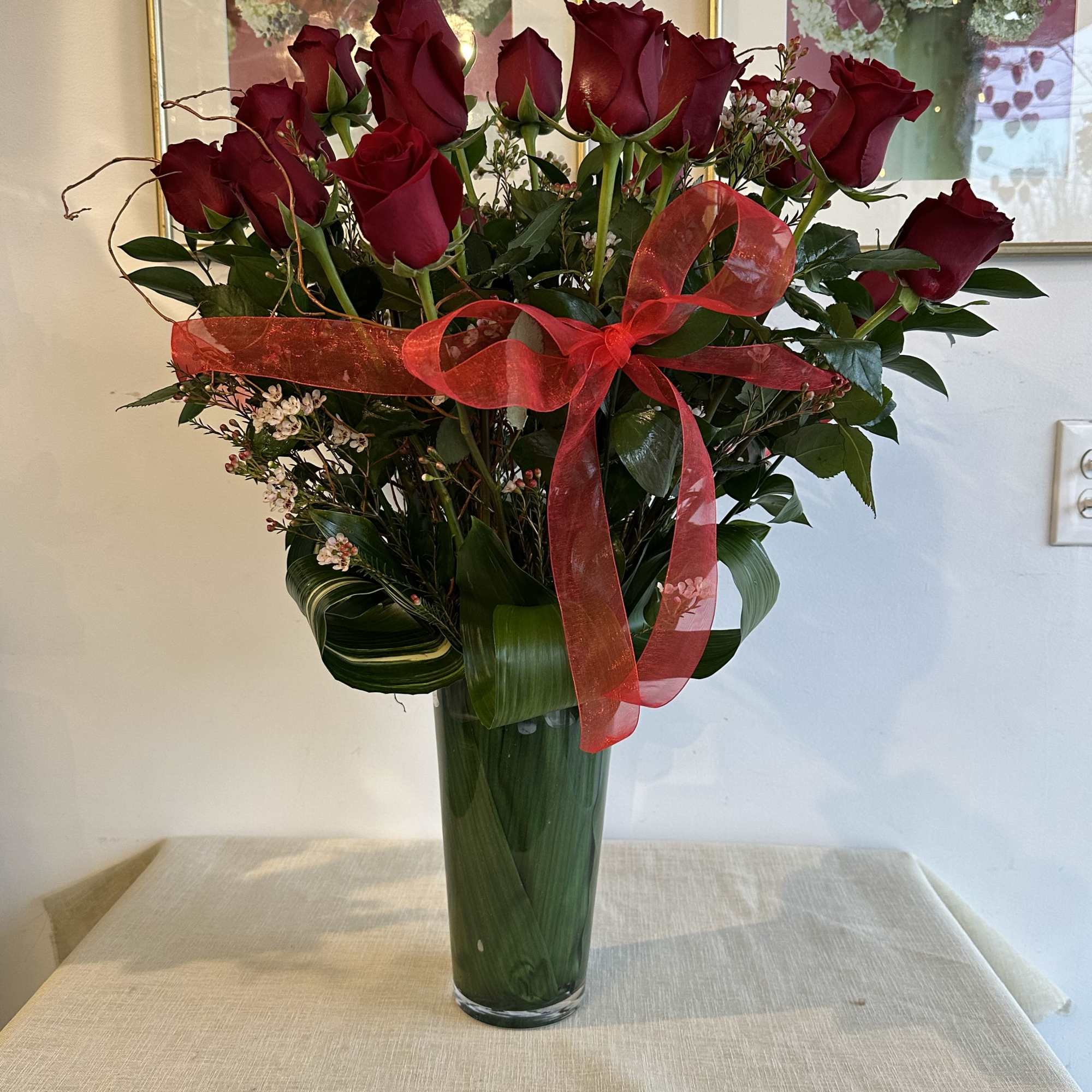 these classic arrangements, accented with seasonal foliage, are available in three stunning