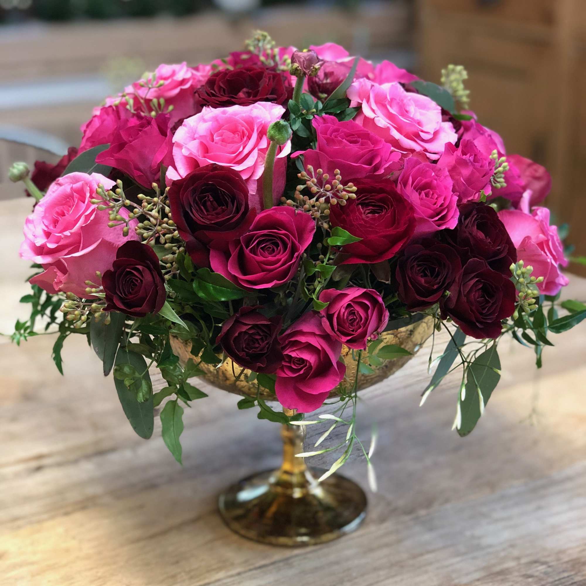 Stunning arrangement!! Arranged in a beautiful gold pedestal vase with an abundance