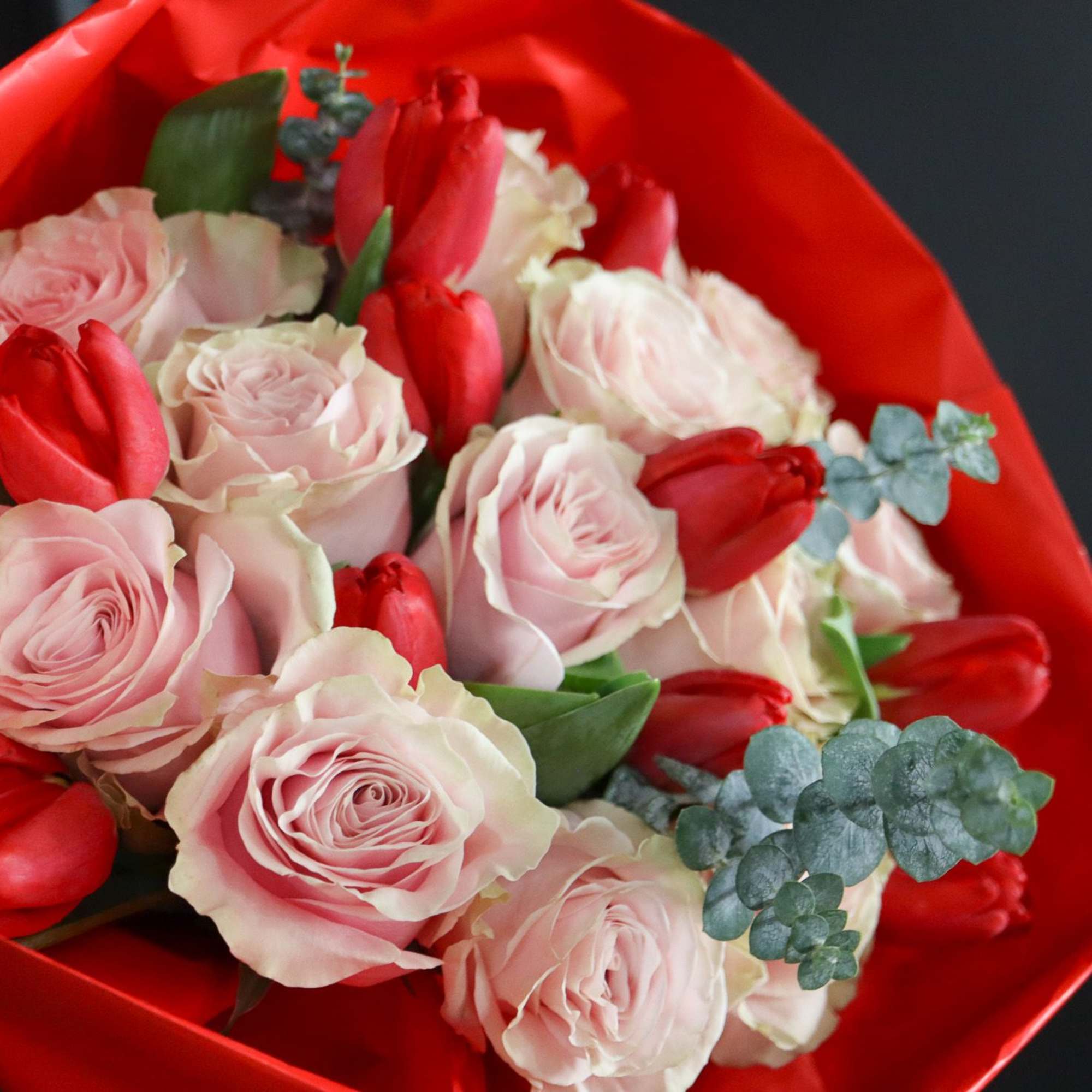 A simple and elegant of 12 pink roses and 10 red tulips.