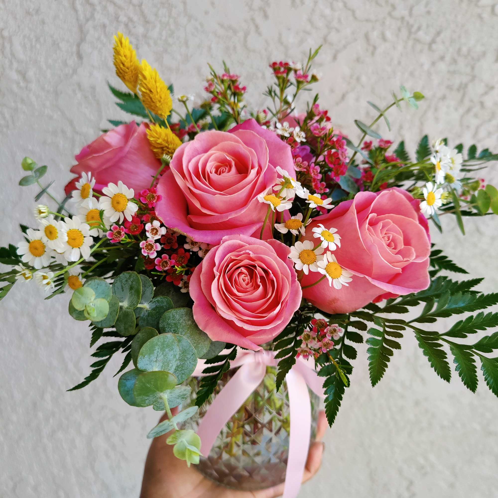 Beautiful fresh seasonal rose arrangement decorated with Hermosa roses, seasonal filler flowers