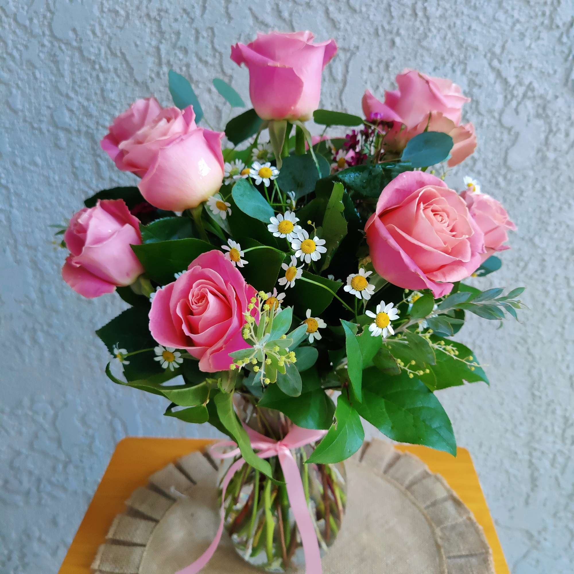 Beautiful fresh seasonal rose arrangement decorated with Hermosa roses, seasonal filler flowers