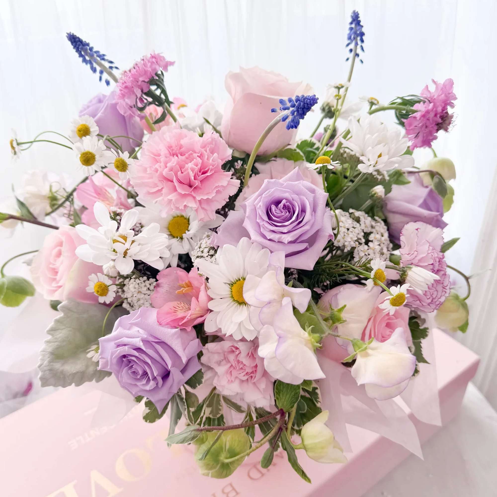 A charming fresh flower arrangement designed to send warmth and love, just
