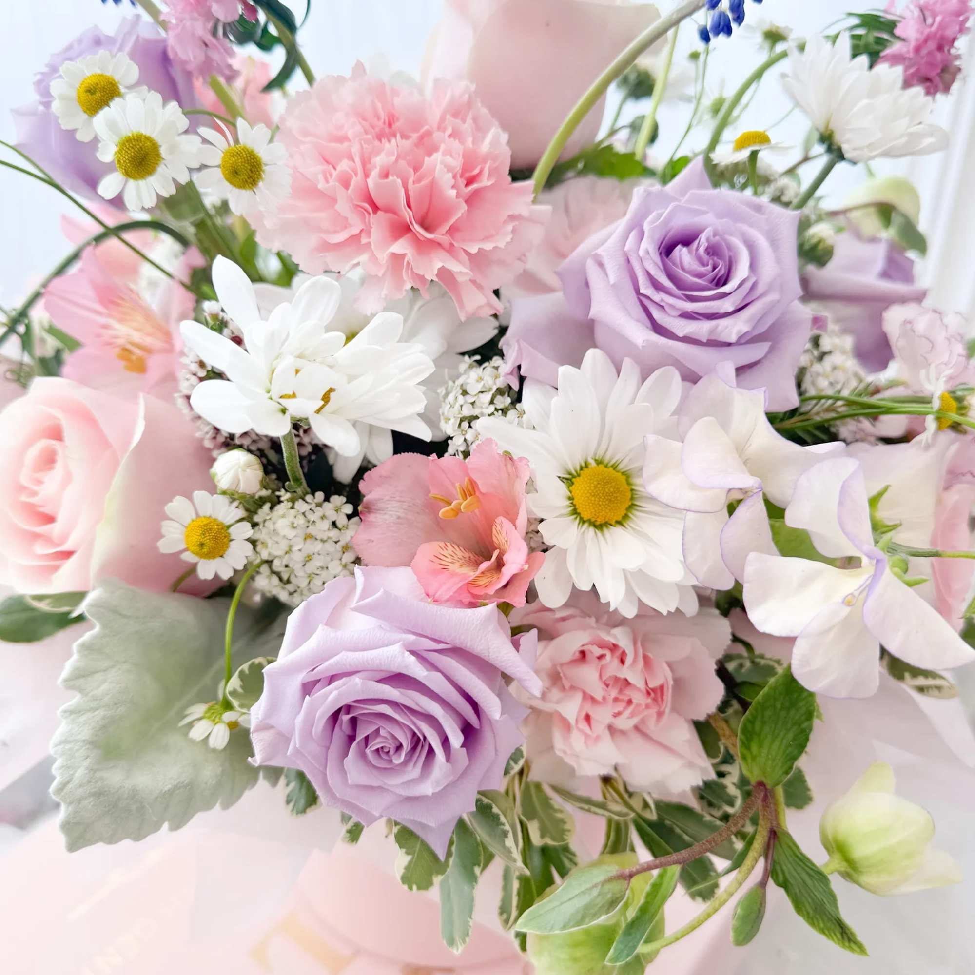 A charming fresh flower arrangement designed to send warmth and love, just