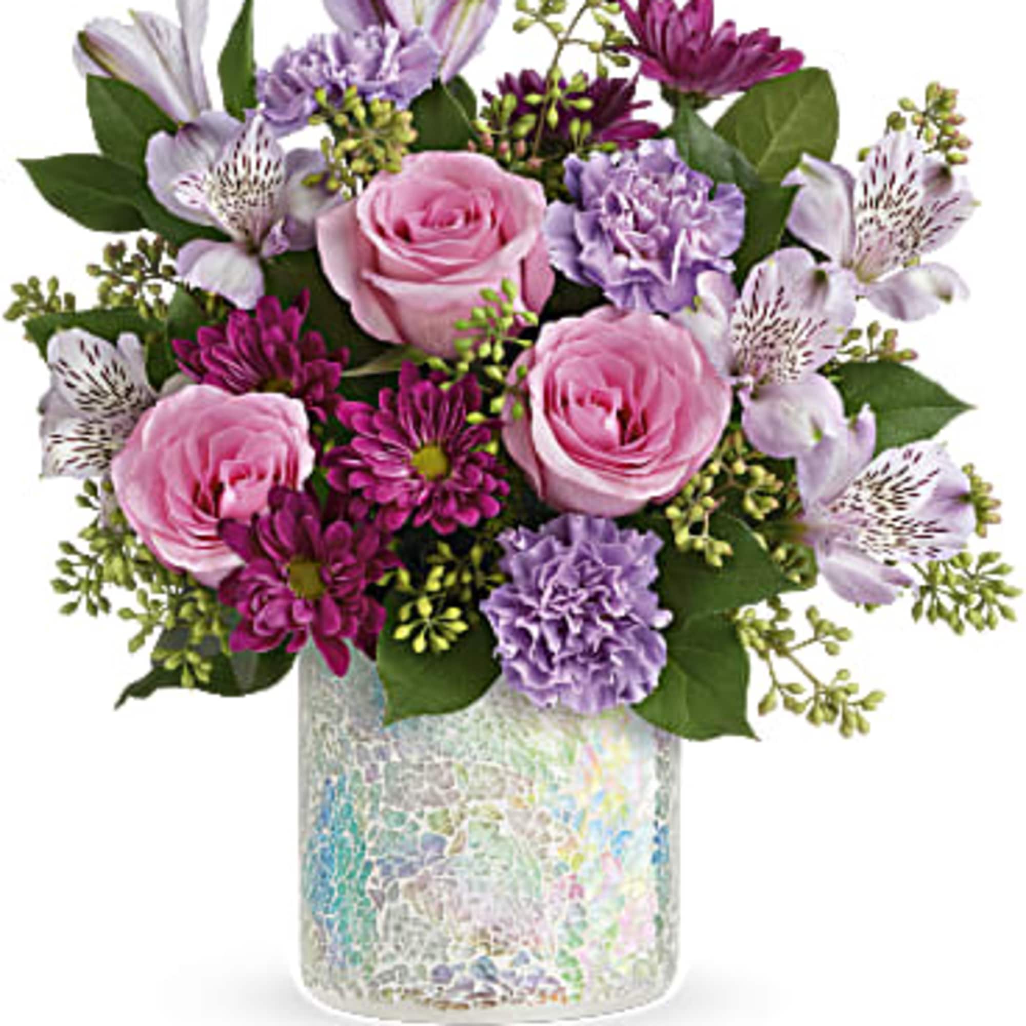 A cheerful mix of soft pink roses, lavender blooms, and vibrant purple