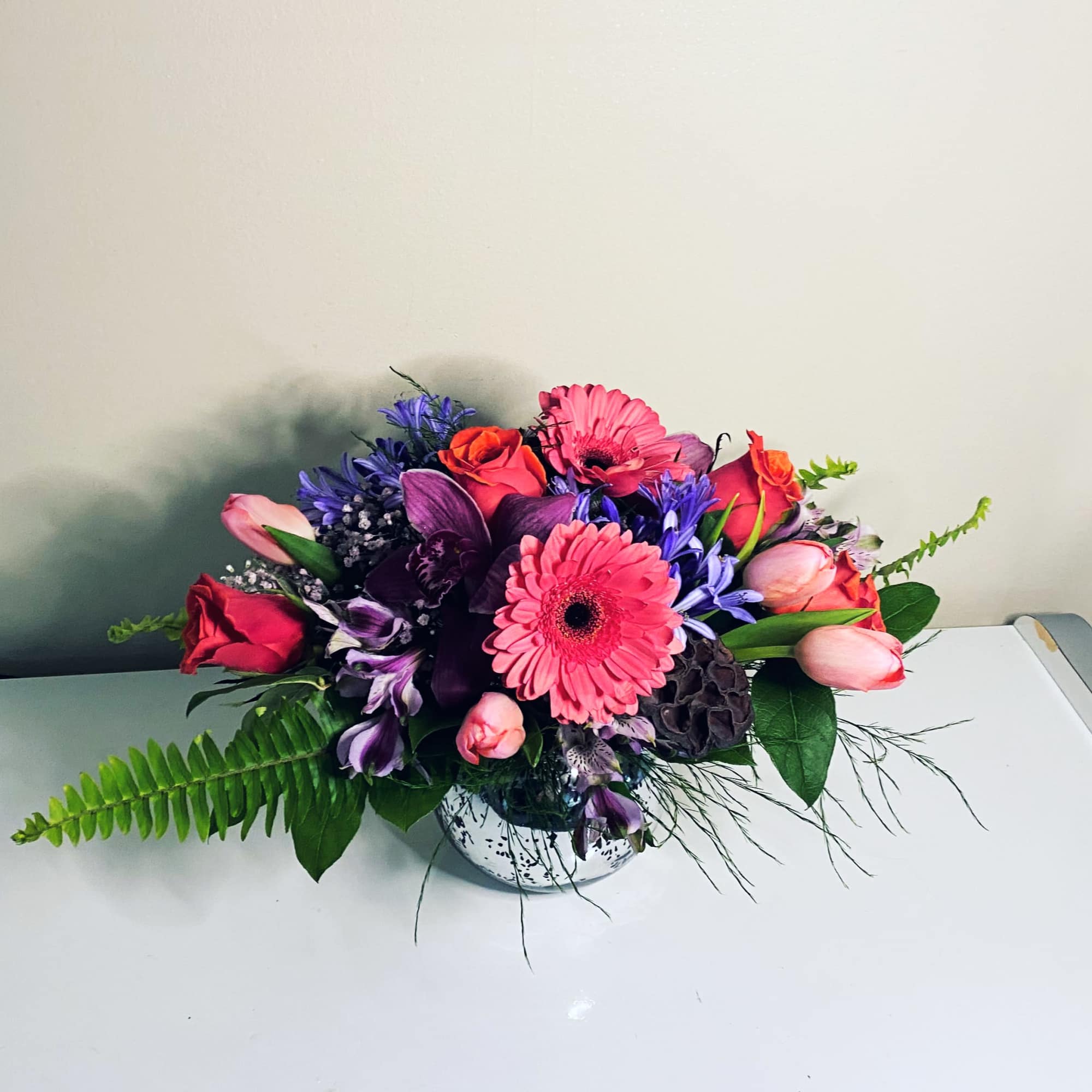 Simple and Elegant Lavender and pink Coral arrangement in silver mercury bowl.