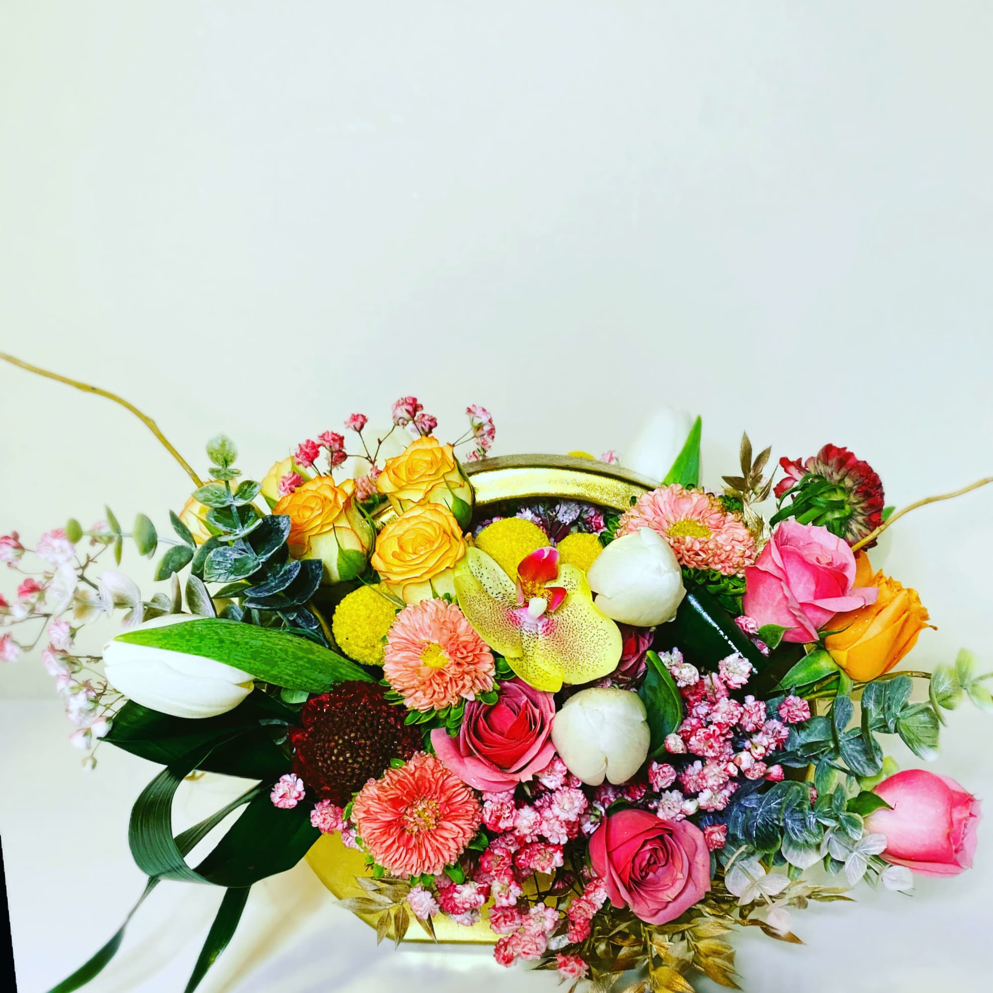 Gold vase with vibrant and happy hues mixed with a touch of