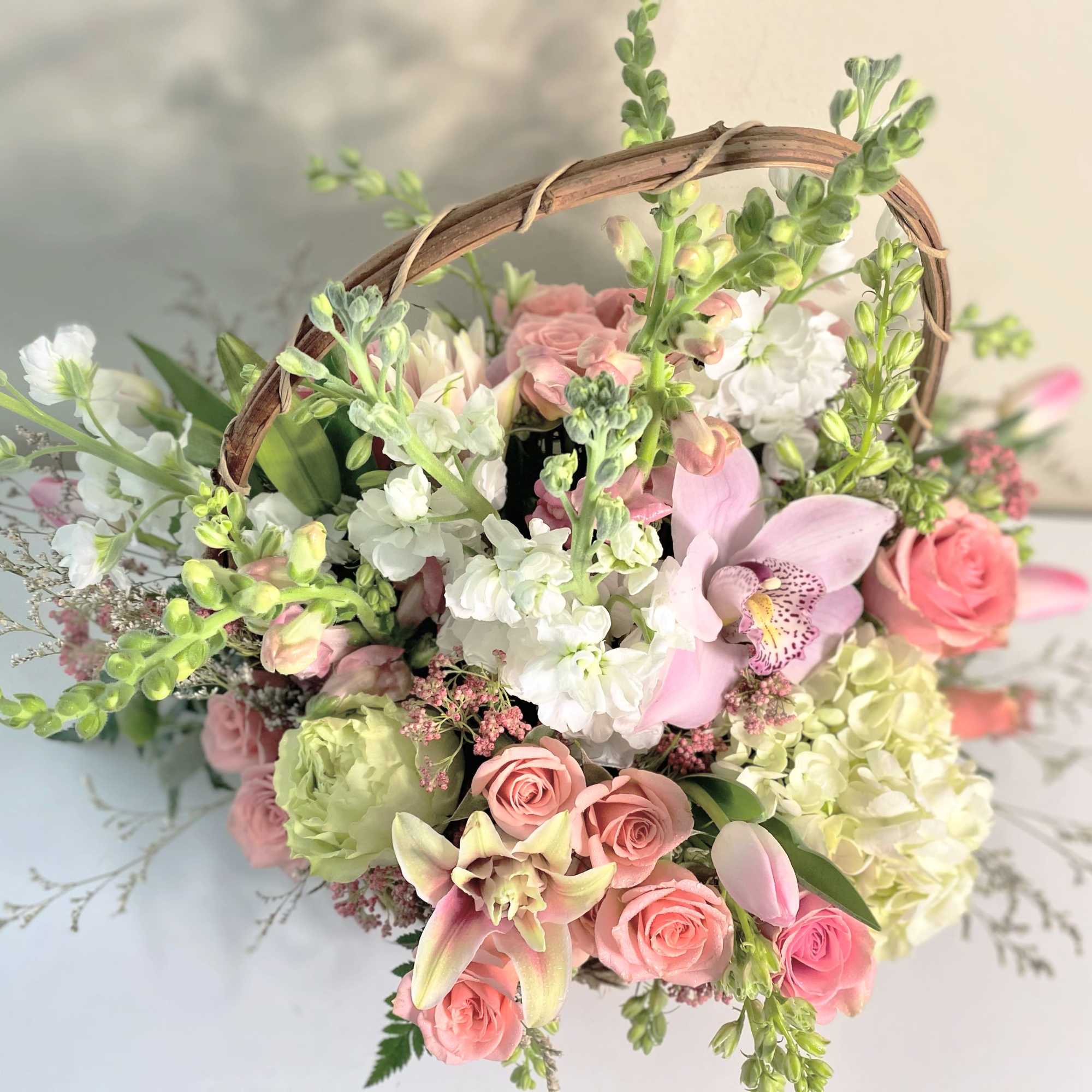 Darling Spring basket is a floral shape of pinks, white and a