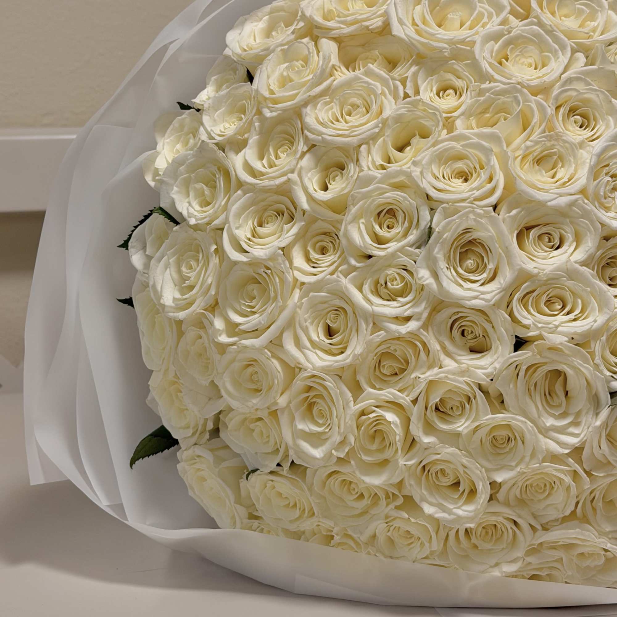 This luxurious arrangement features a grand, dome-shaped composition of pristine 99 white