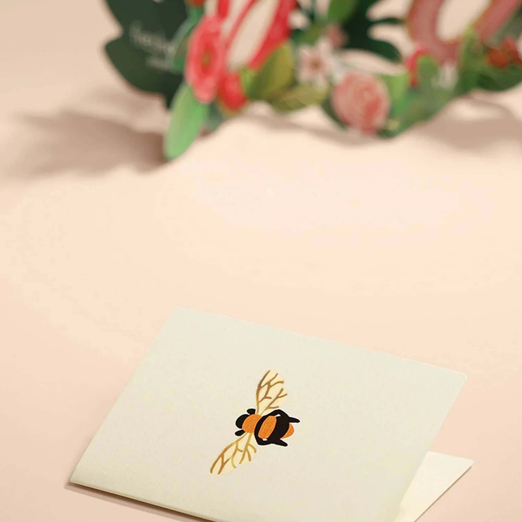 Shining with gold foil and sprouting with pink and red roses and