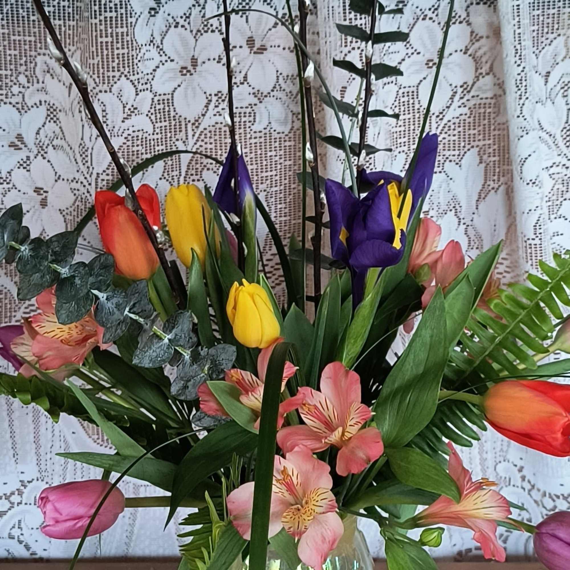 A mix of the freshest spring florals arranged in a glass vase.