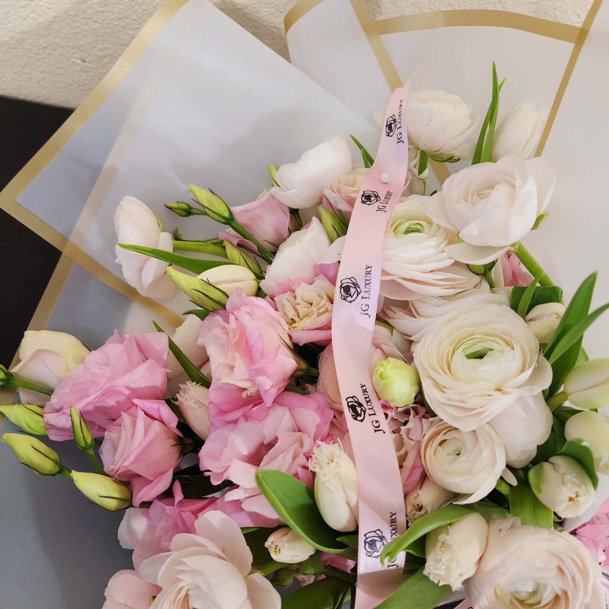 Delicate arrangement made with love, blending soft pink lisianthus, graceful white tulips