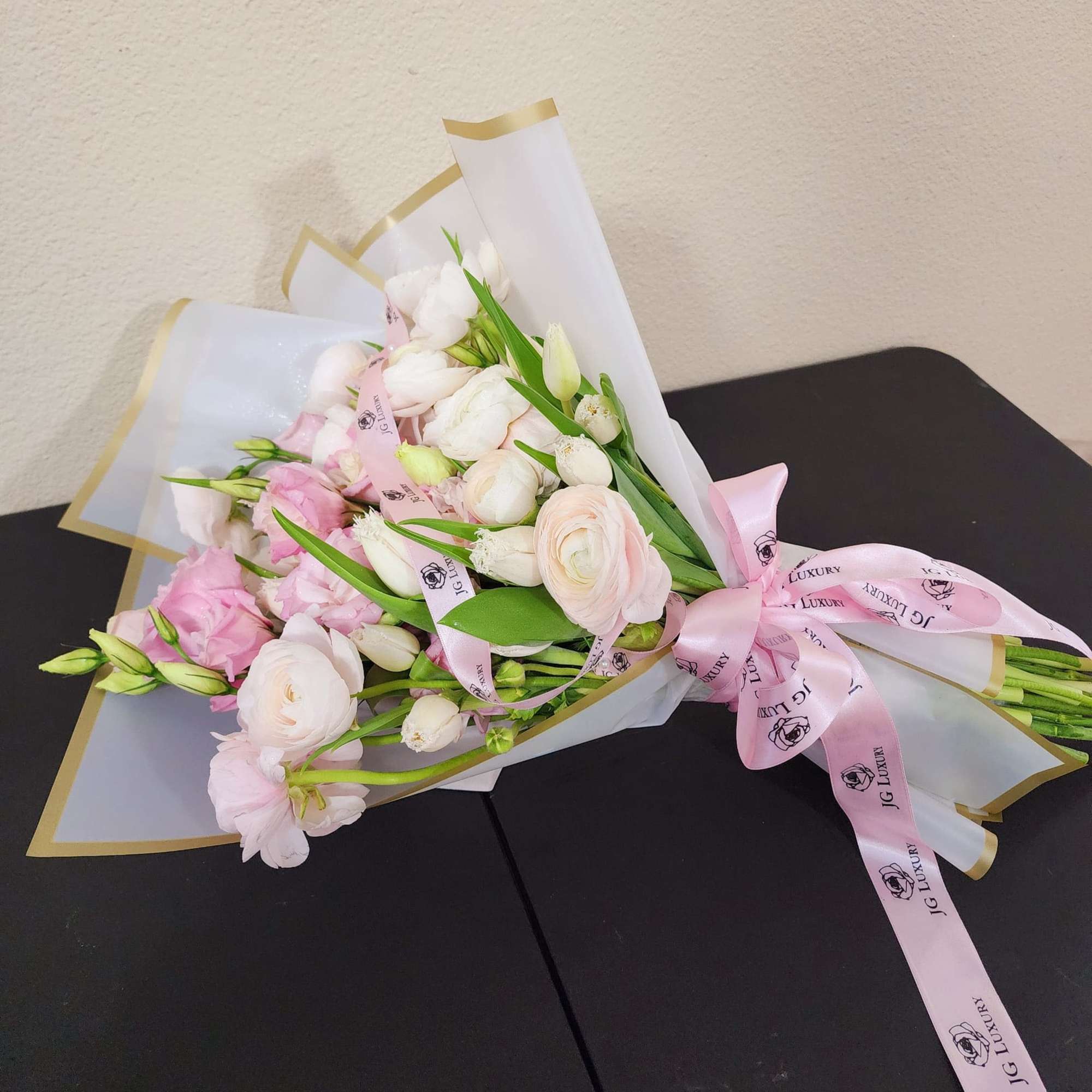 Delicate arrangement made with love, blending soft pink lisianthus, graceful white tulips