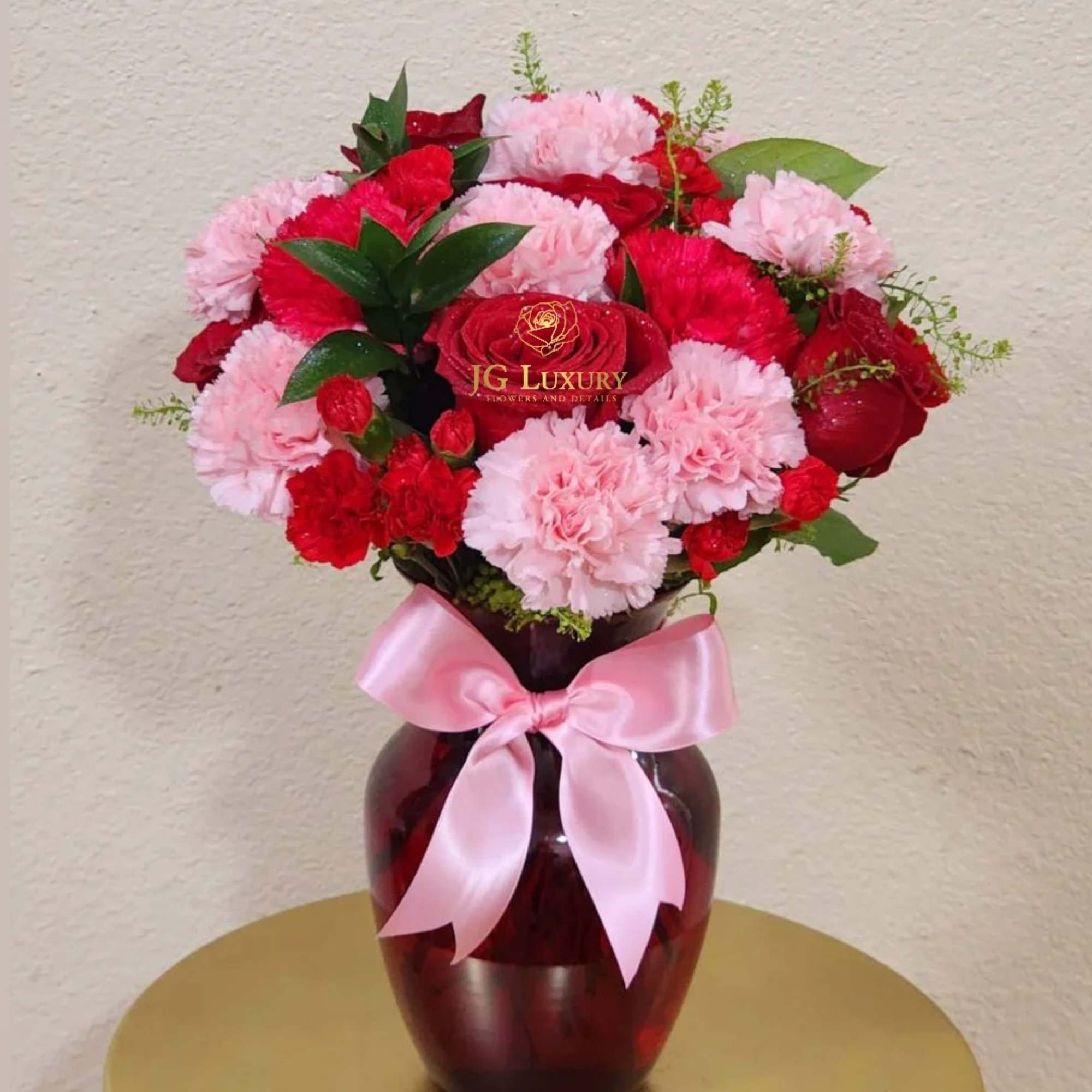 Carnations, roses, greens, rucus and mini carnations means a mix of blooms