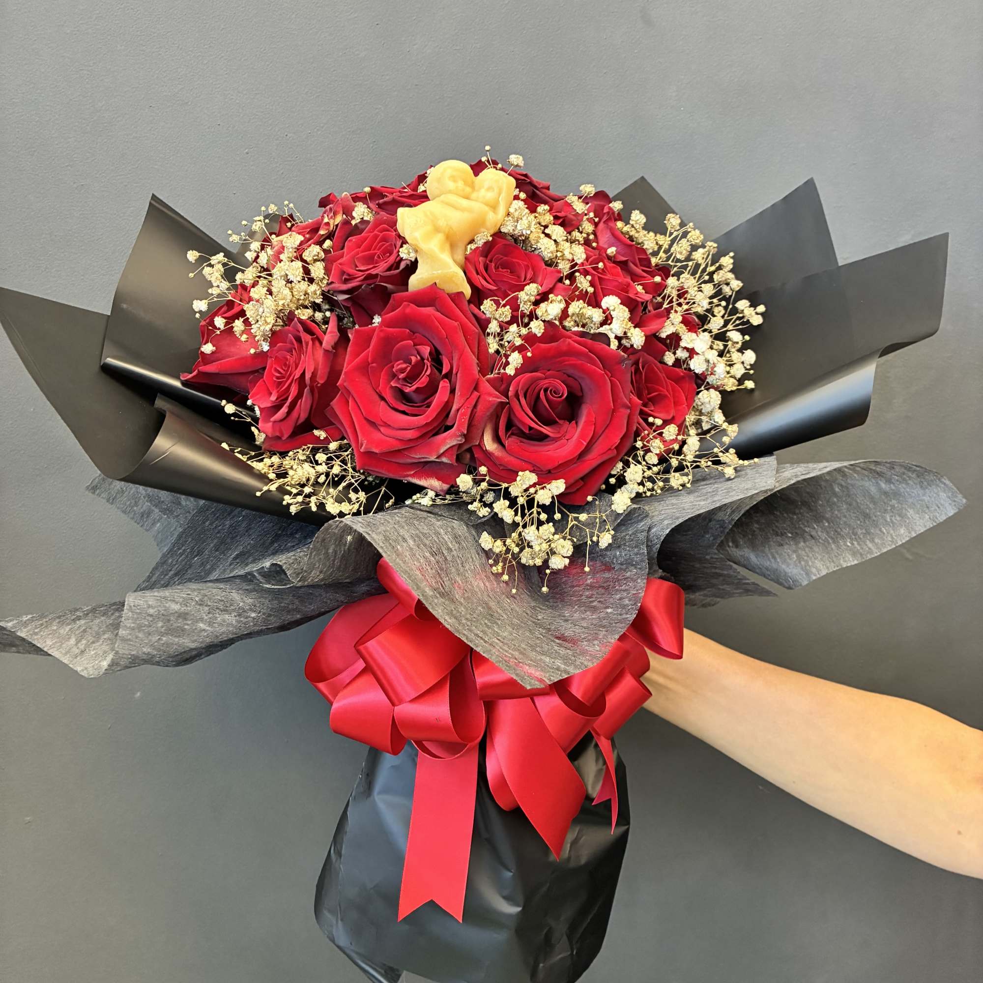 Two Dozen roses with golden baby&rsquo;s breath with an all natural beeswax