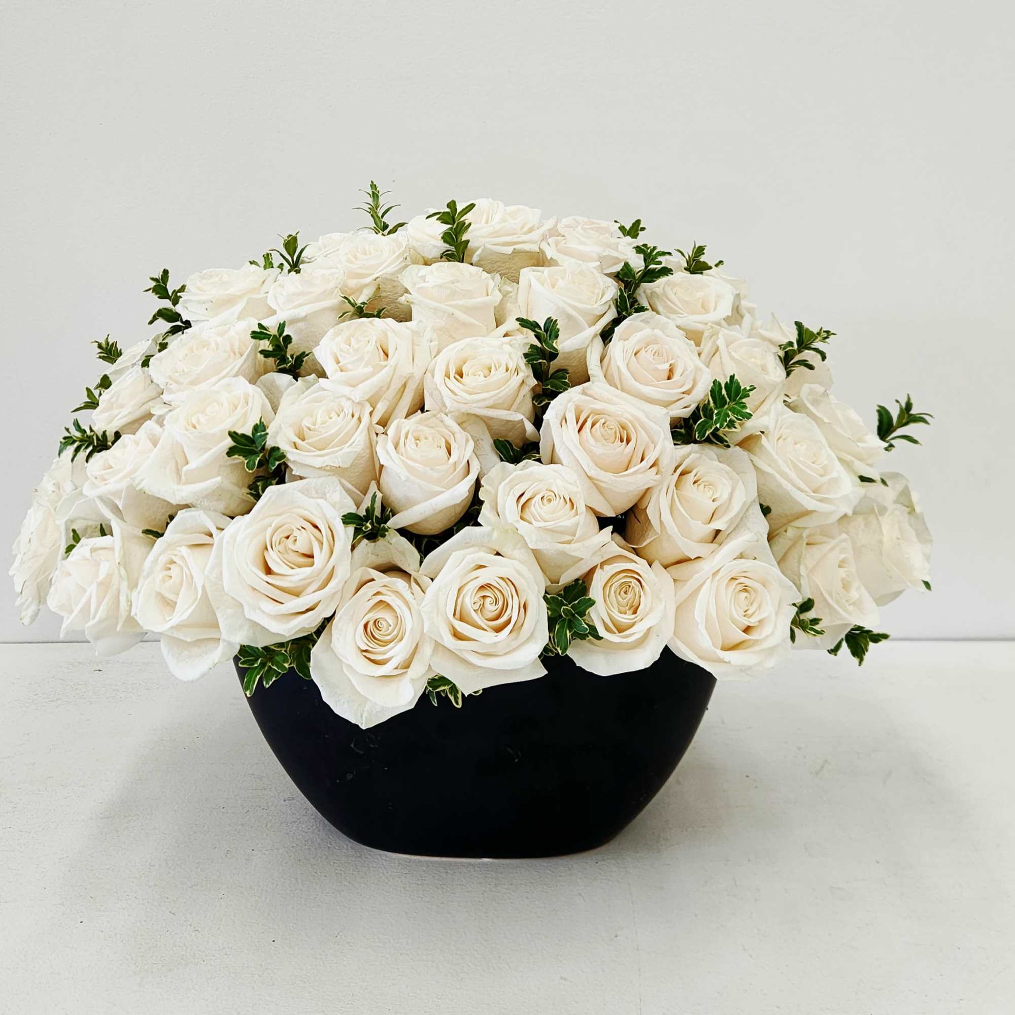 5 dozen Premium White Roses in a ceramic vase.

Express pure and sincere