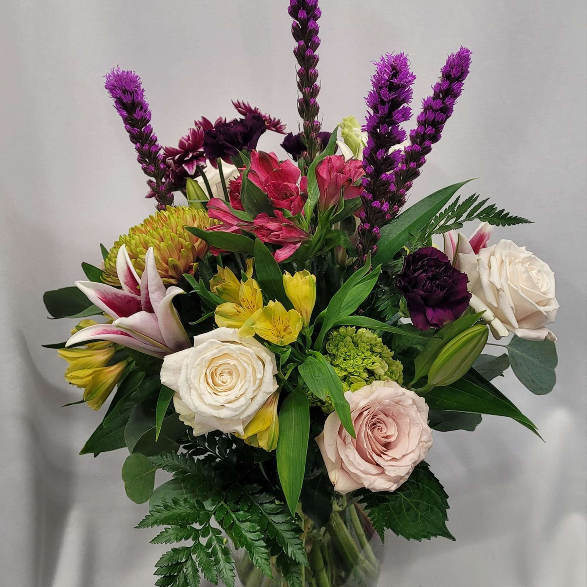 Mixed arrangement of hydrangea roses, liatris ,Daisy's, Alstroemeria carnations, and delphinium it's