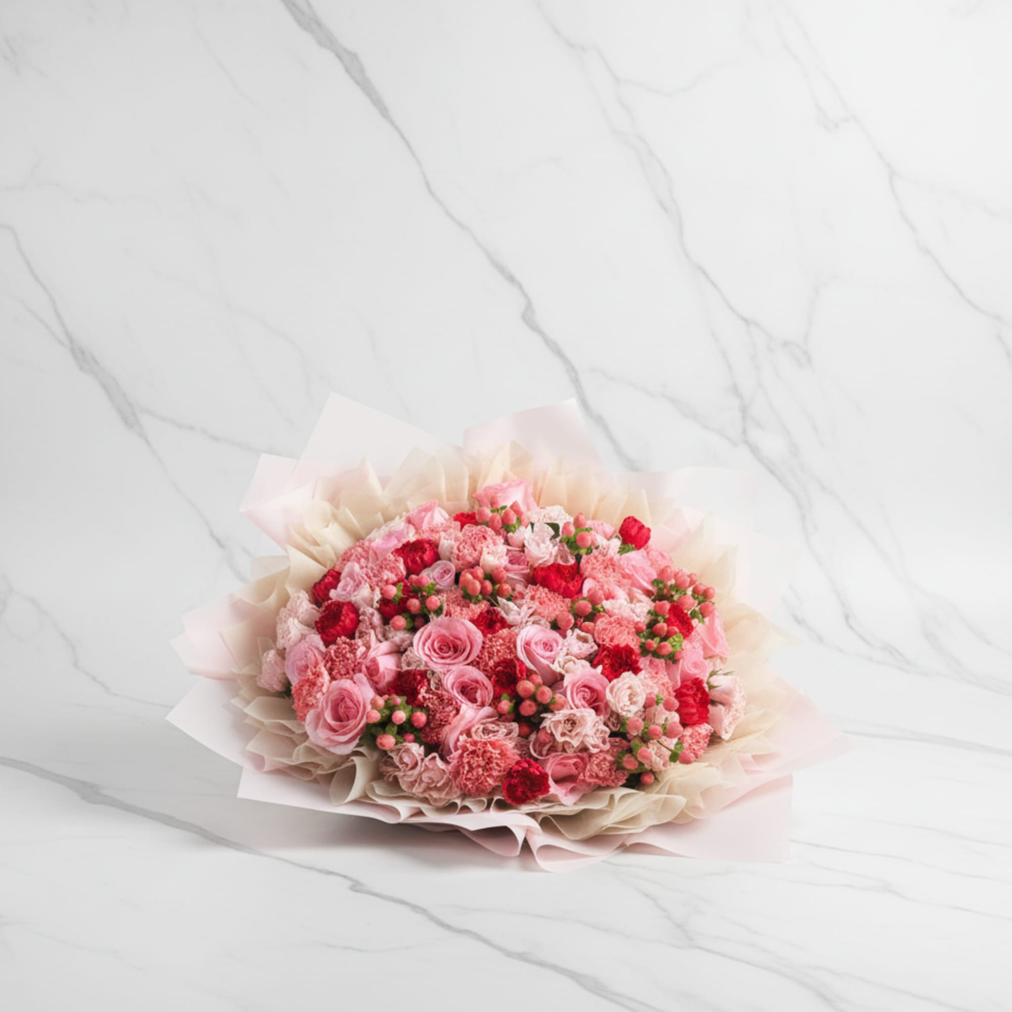 A beautifully wrapped bouquet that&rsquo;s filled with blooms in a color palette