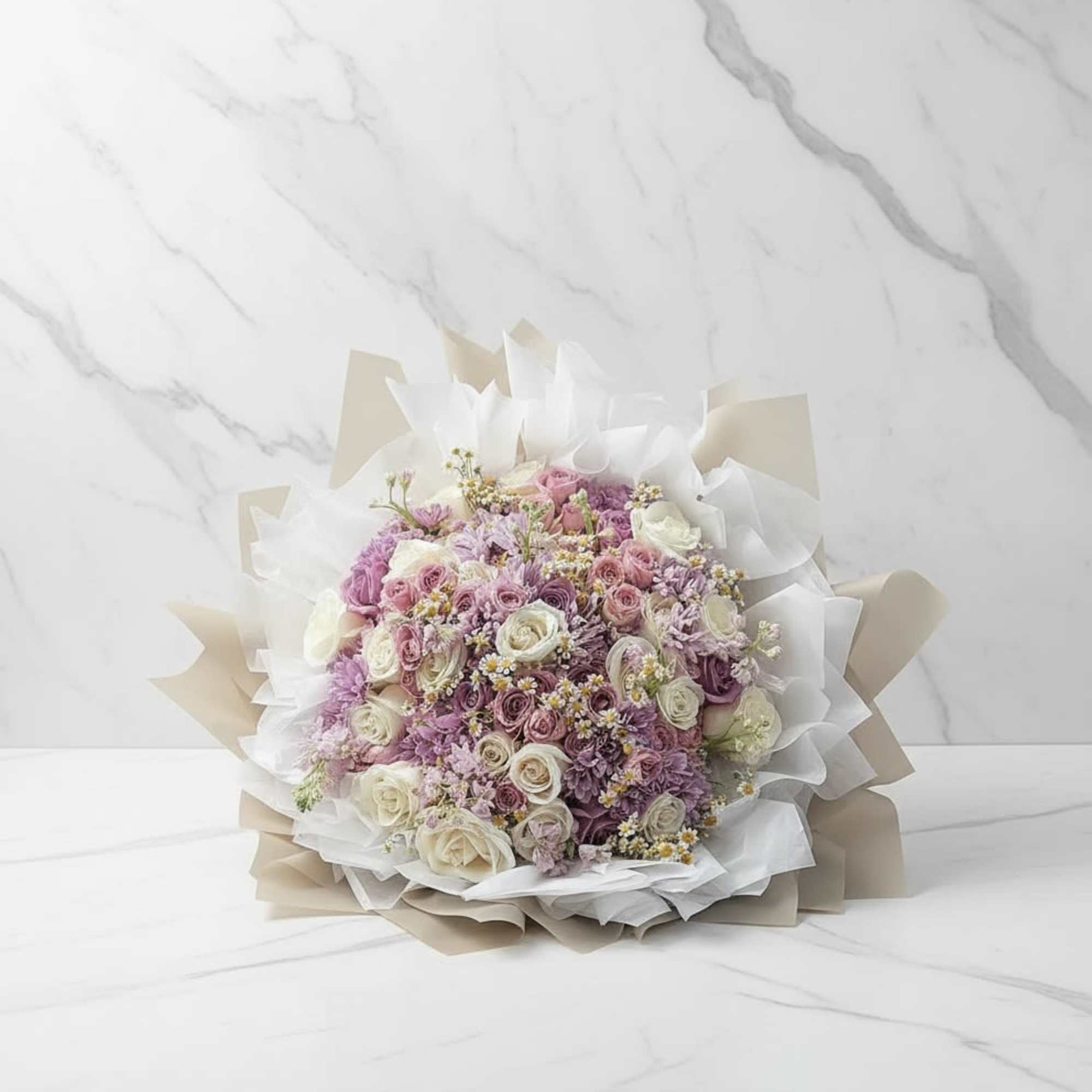 A beautifully wrapped bouquet that&rsquo;s filled with blooms in a color palette