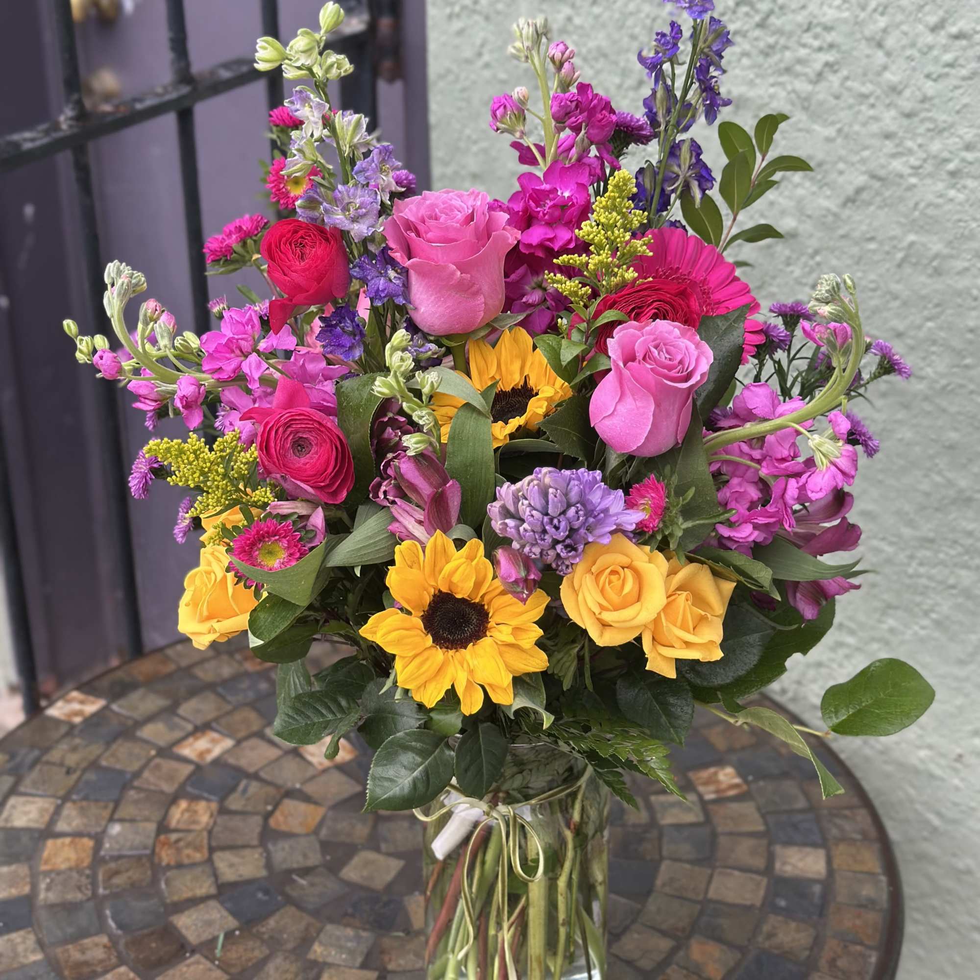 Beautiful happy flowers in array of bright colors, featuring mini sunflowers, larkspur