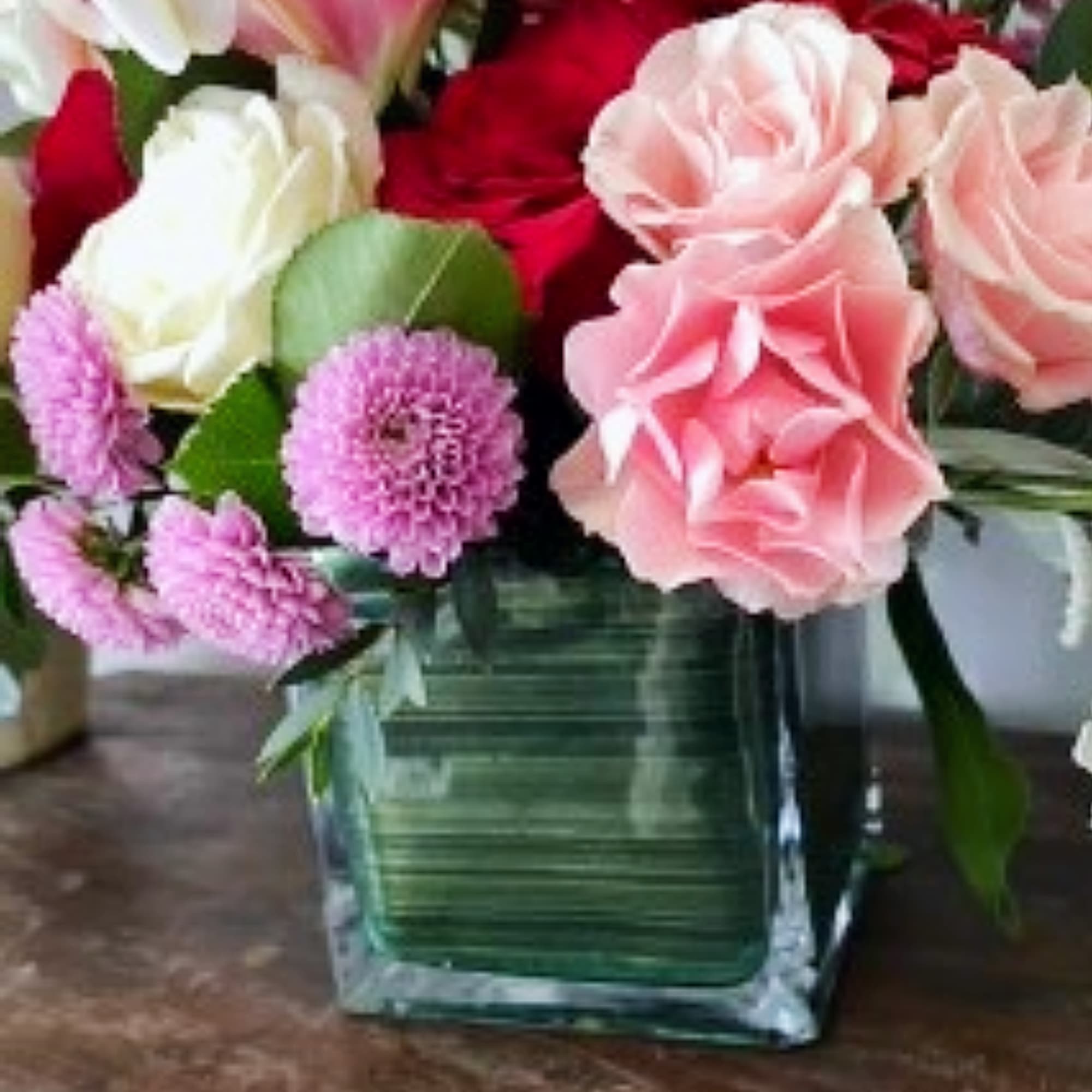 The arrangement is naturally stylized, with touches of blossomy flowers added for