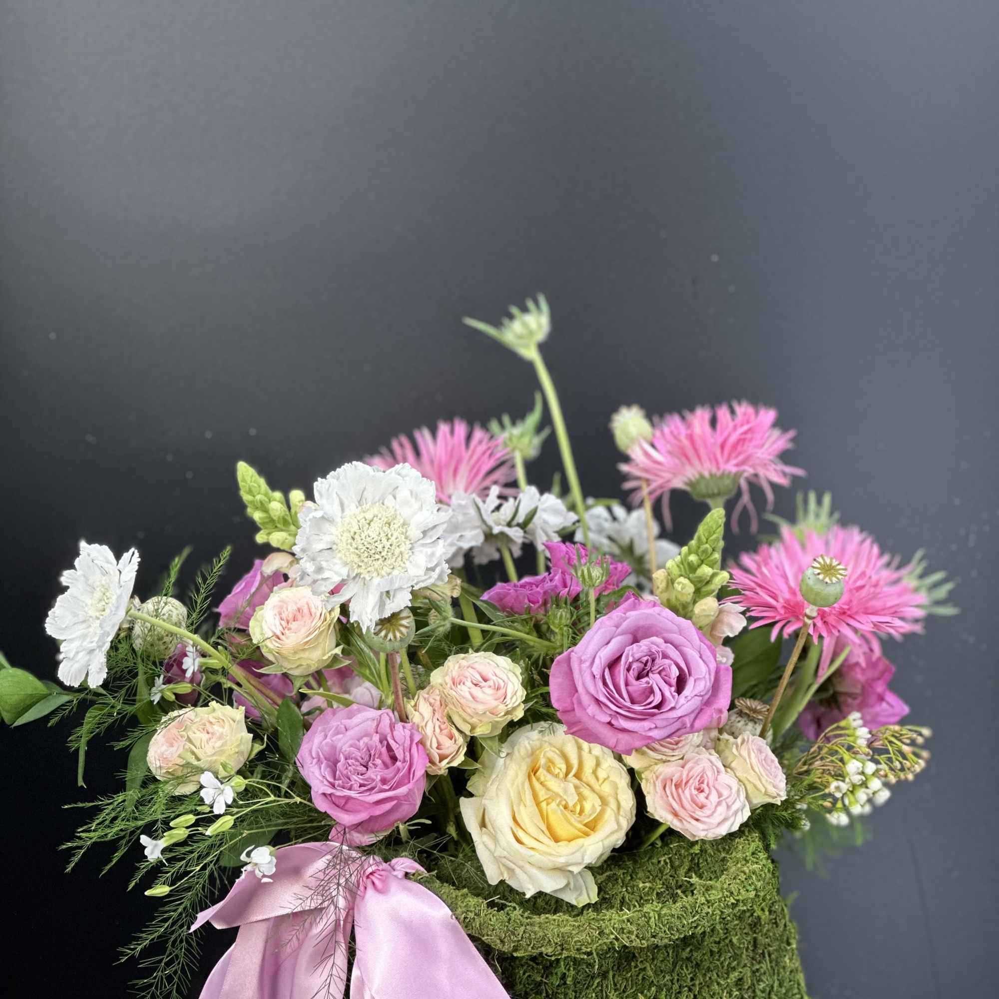 Refined ,low -profile floral arrangement composed of blush and rose -toned layered