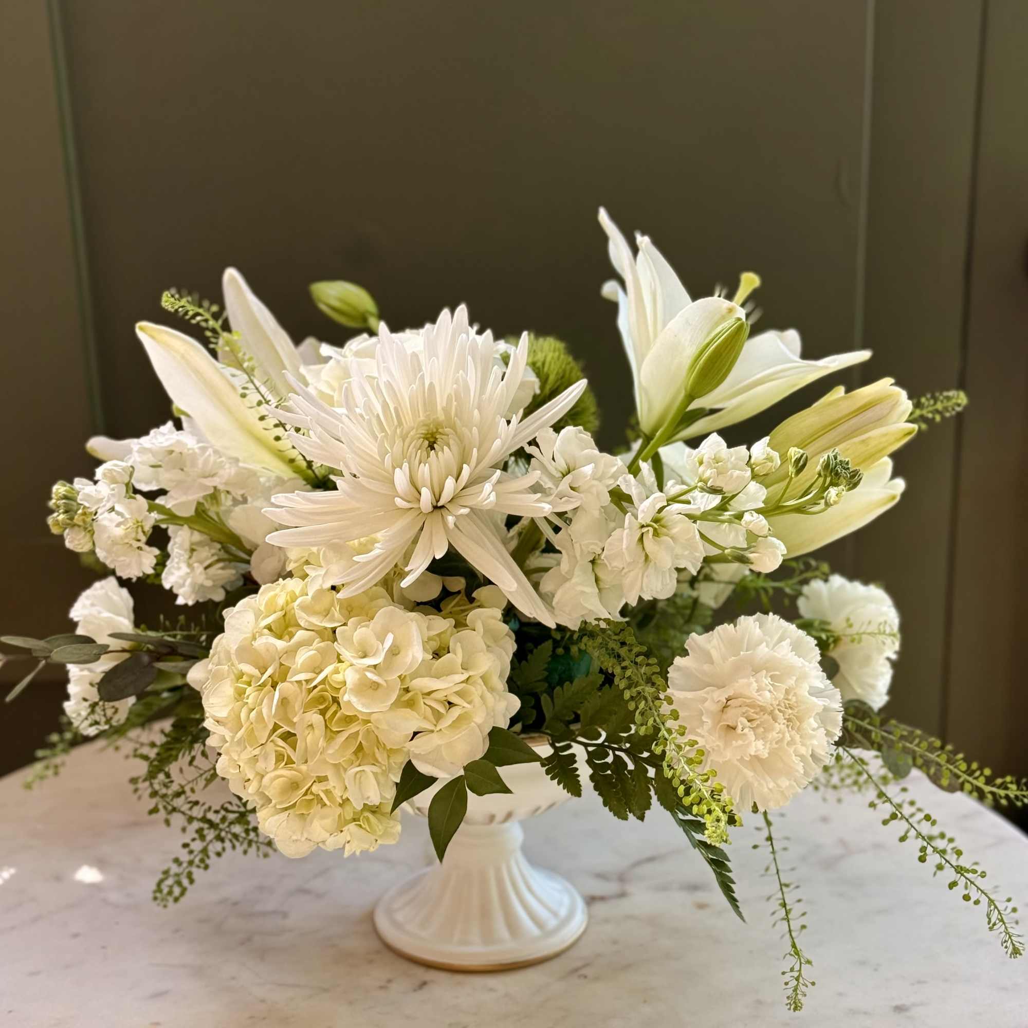 An all white and green floral design for moments that deserve a
