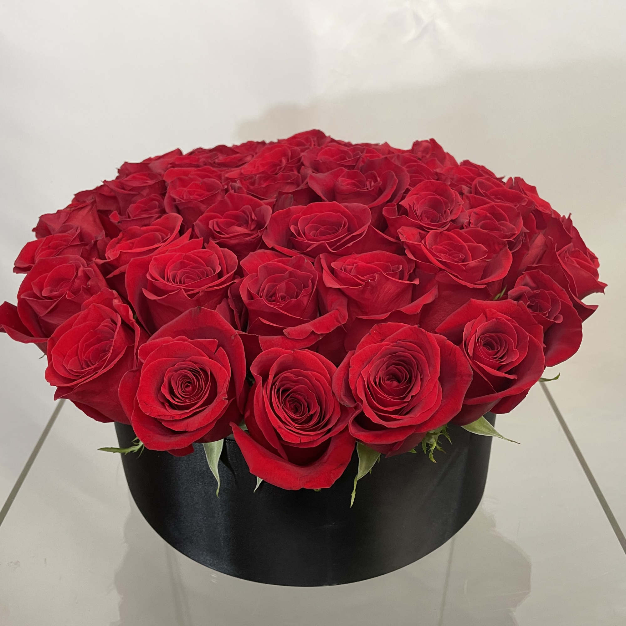 An abundance of red roses in this elegant, tight, compact, high end