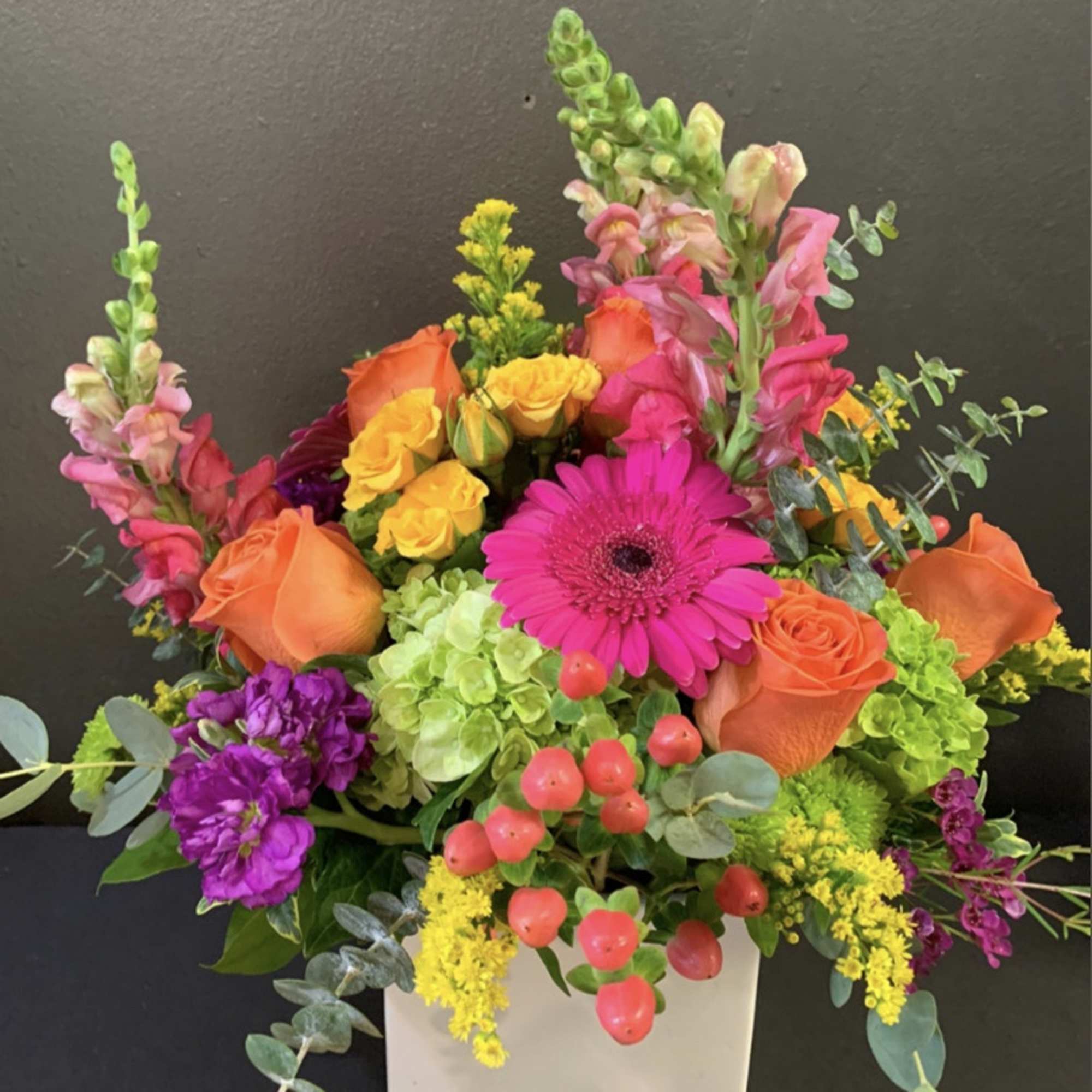 Turn up the heat with the vivacious bouquet. This arrangement includes roses