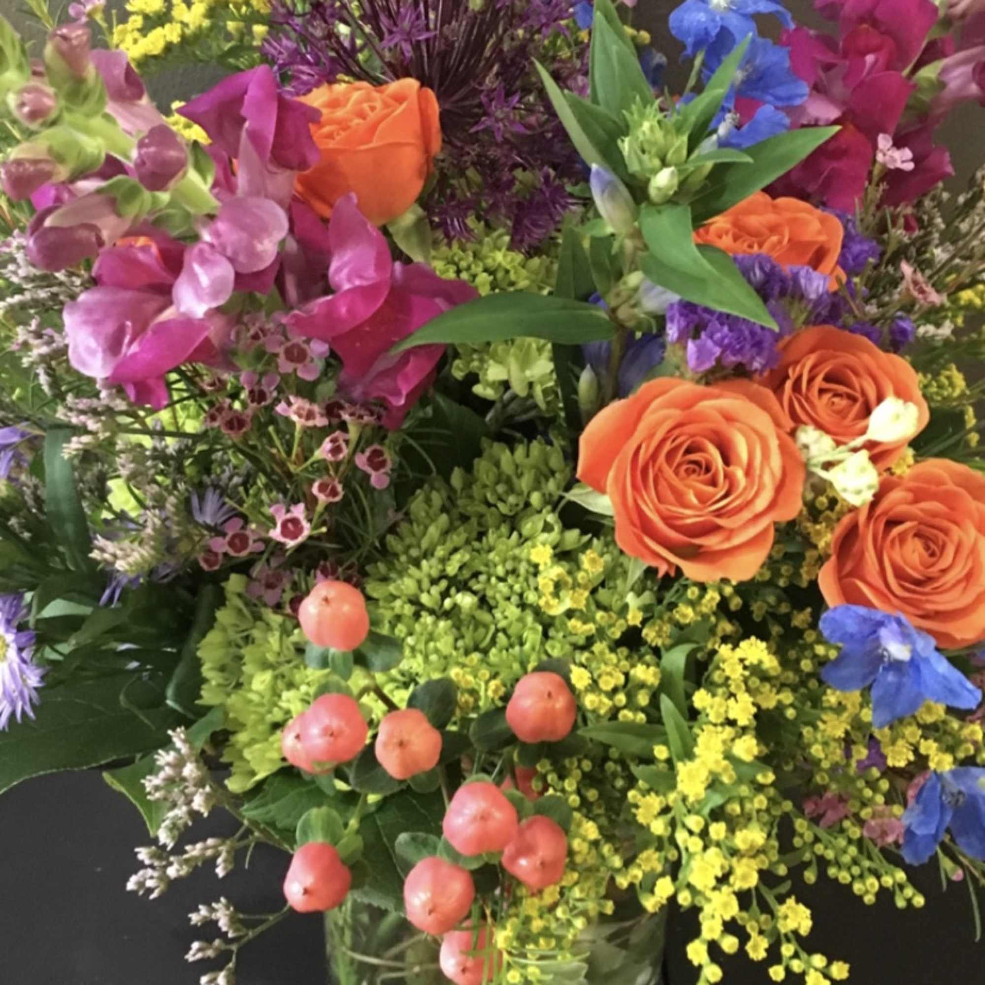 Beautiful snapdragons, roses and hydrangeas will be arranged with complementary additional flowers.