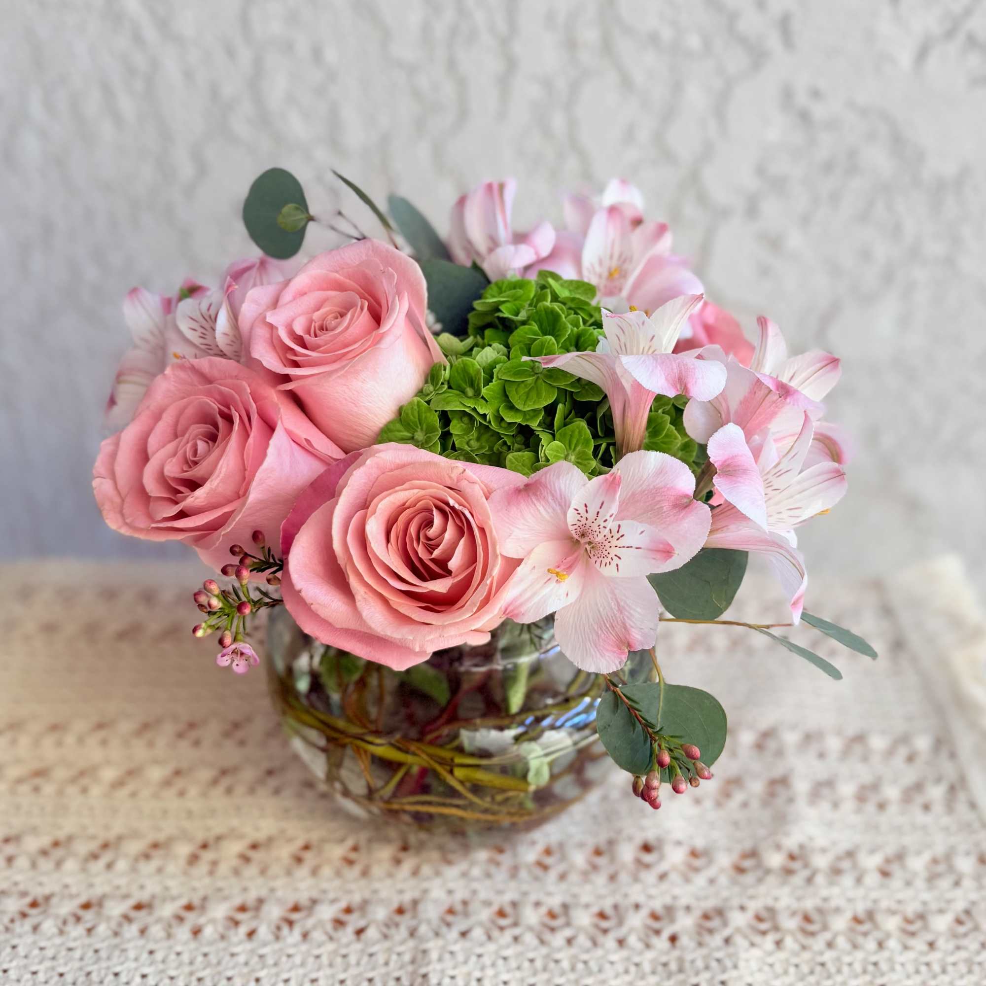 Send joy with this beautiful floral arrangement designed with roses, green hydrangeas