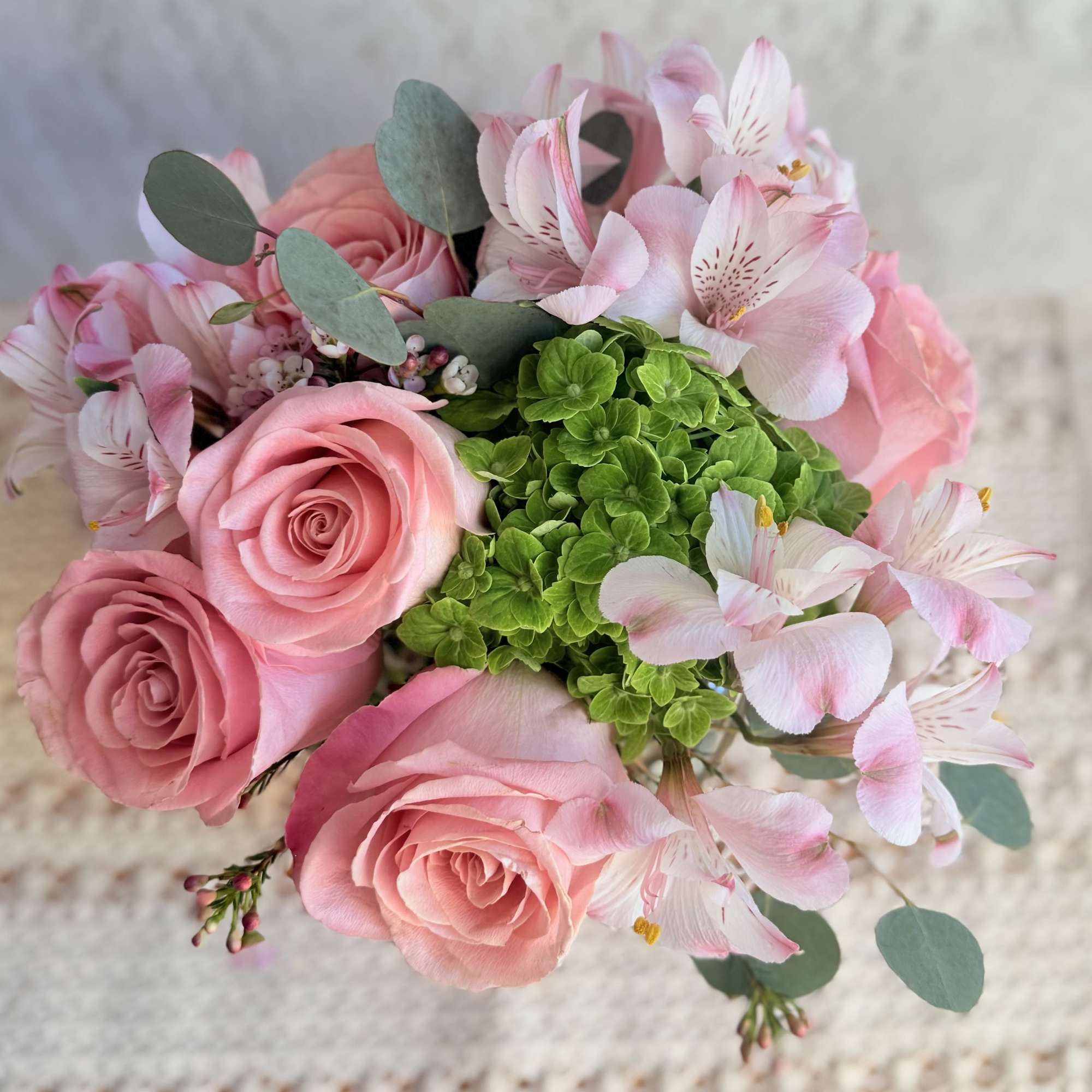 Send joy with this beautiful floral arrangement designed with roses, green hydrangeas