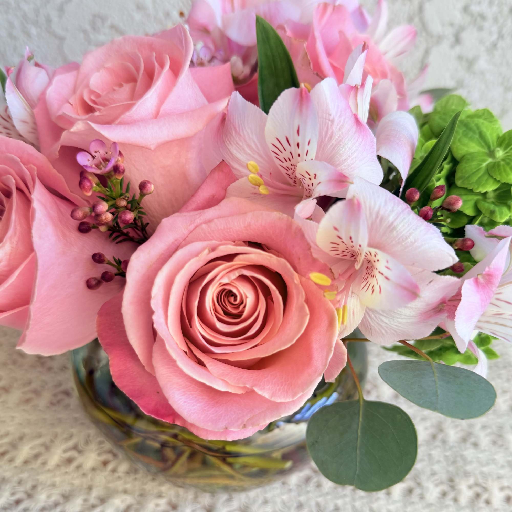 Send joy with this beautiful floral arrangement designed with roses, green hydrangeas