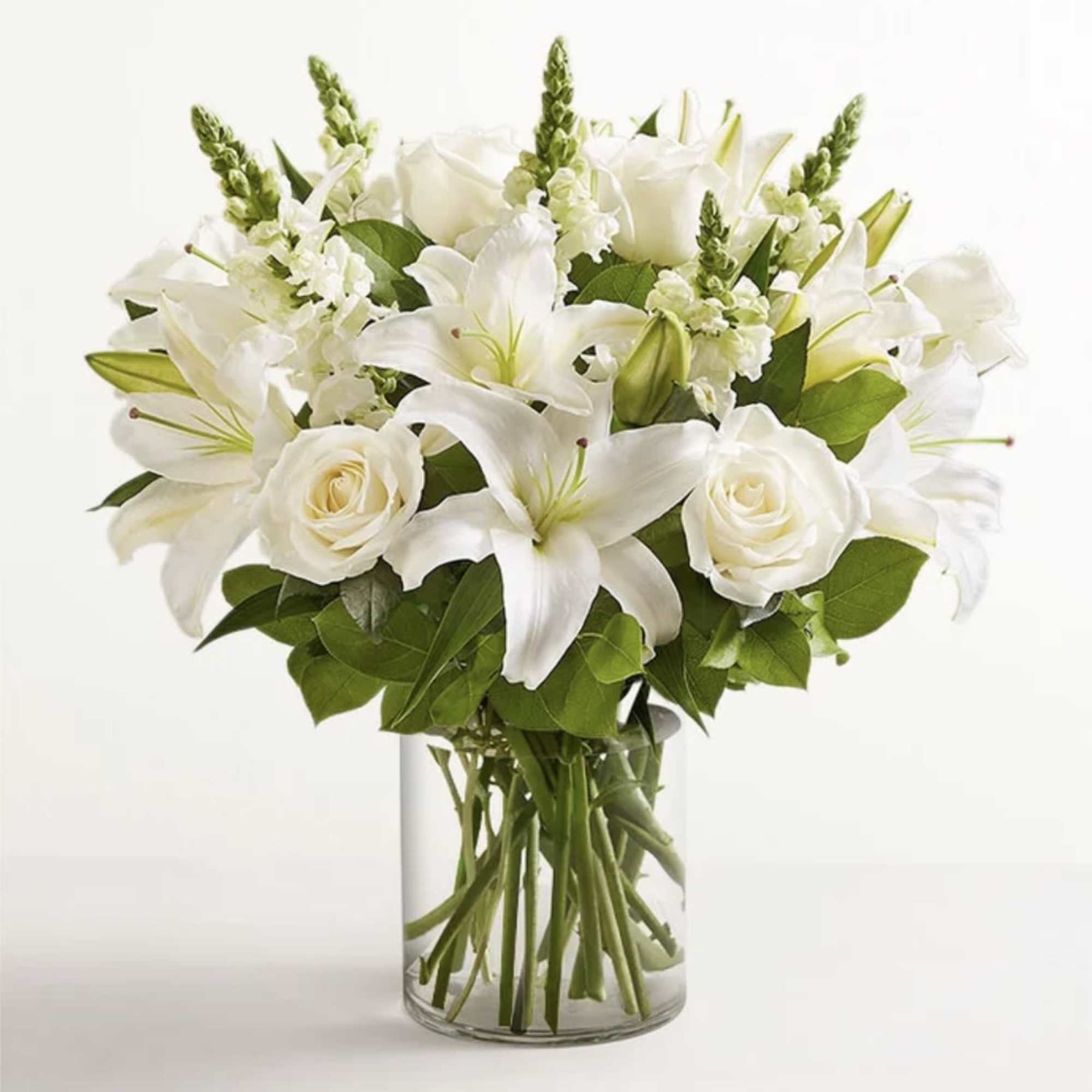 All-around arrangement with all white flowers, designed in a glass cylinder vase.
Standard