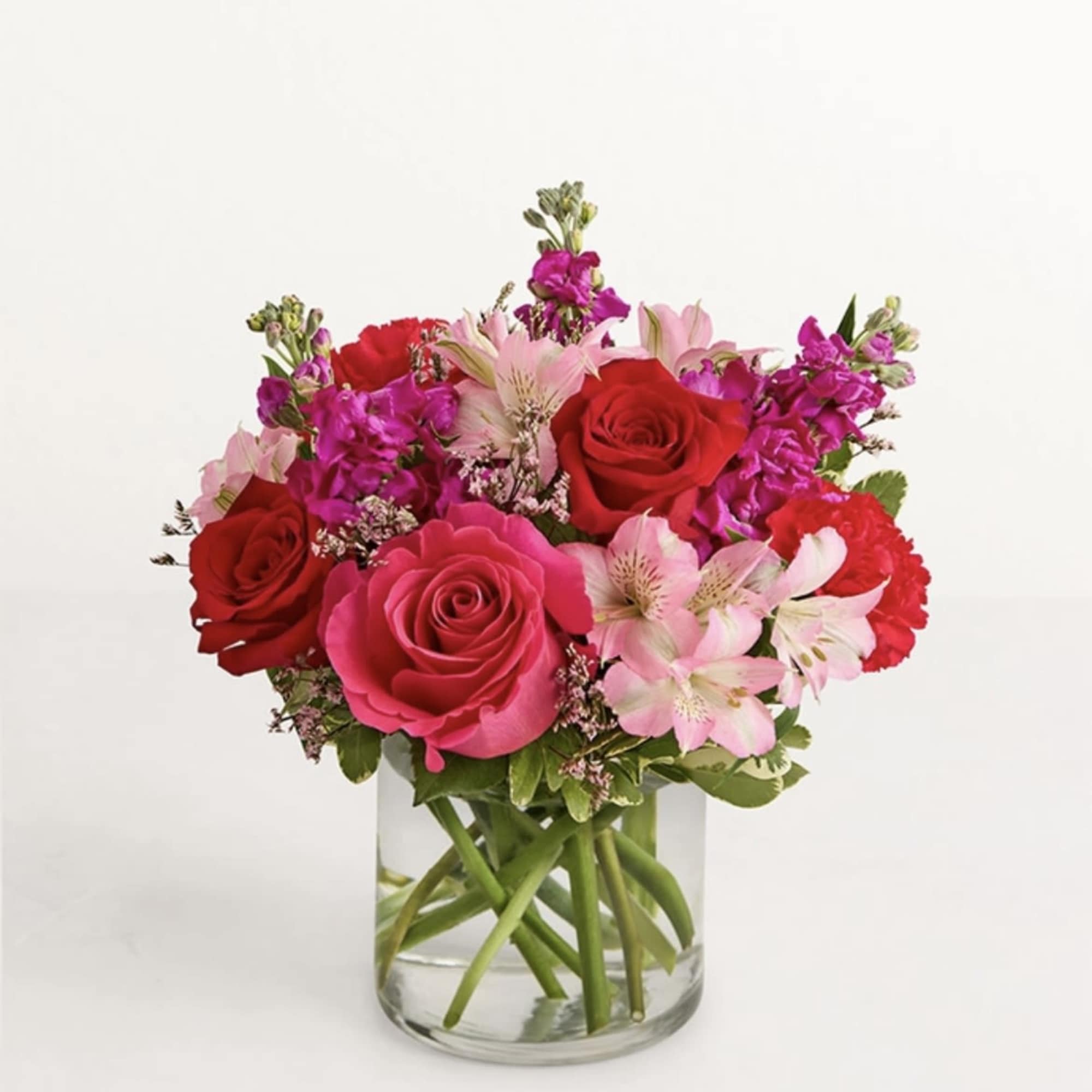 all-around arrangement reds and pinks, designed in a clear glass cylinder vase.
standard/deluxe
