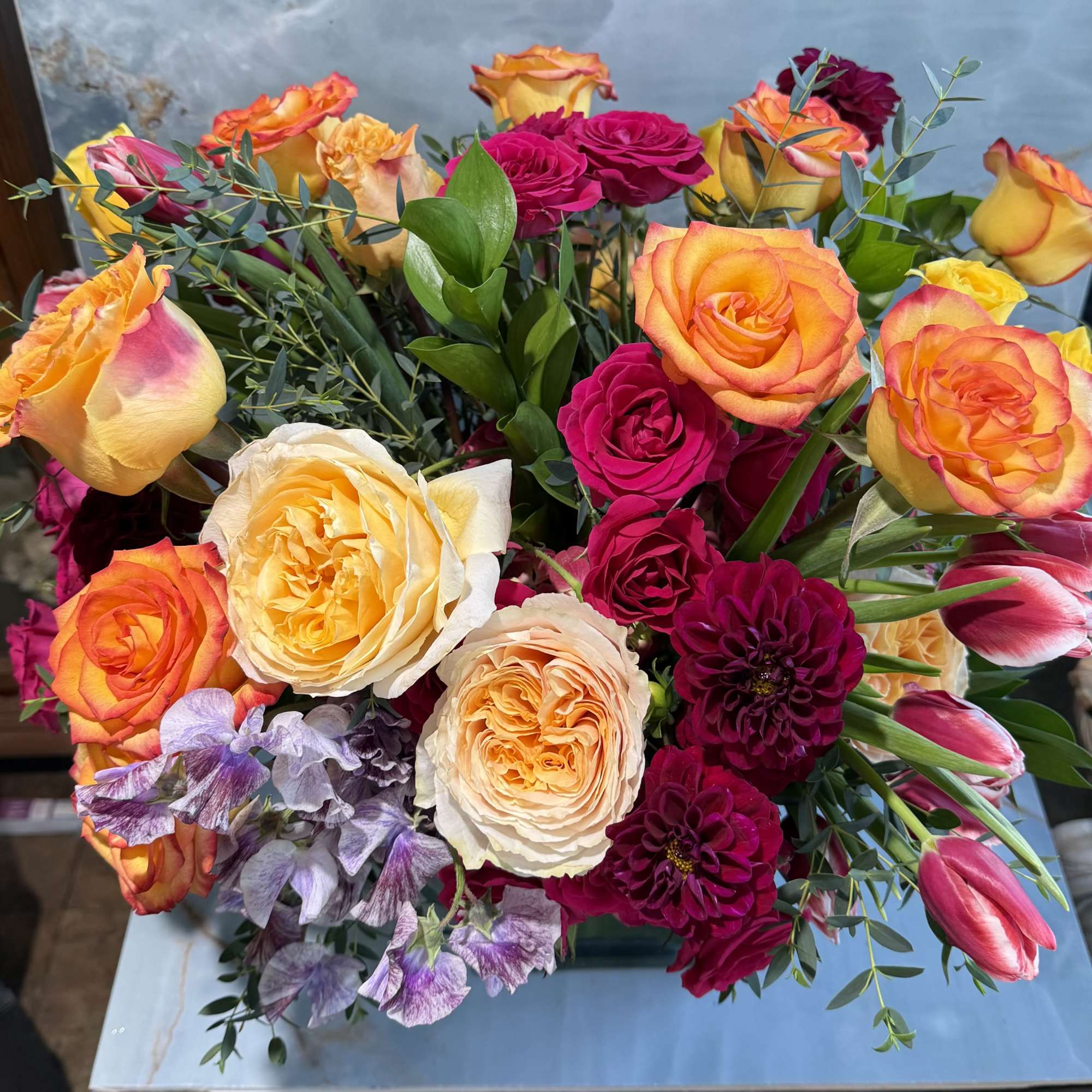 This arrangement is lush, garden-inspired, and joyfully expressive. It features a rich