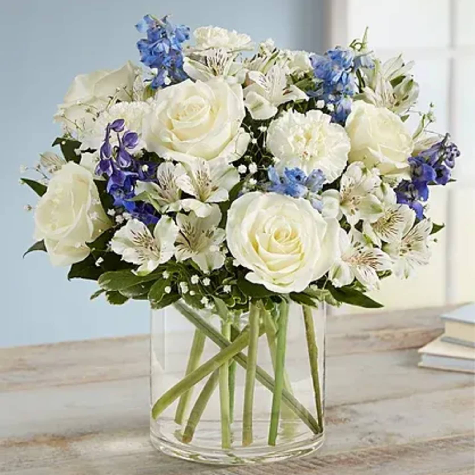 All-around arrangement with white roses, carnations and Peruvian lilies (alstroemeria); blue delphinium;