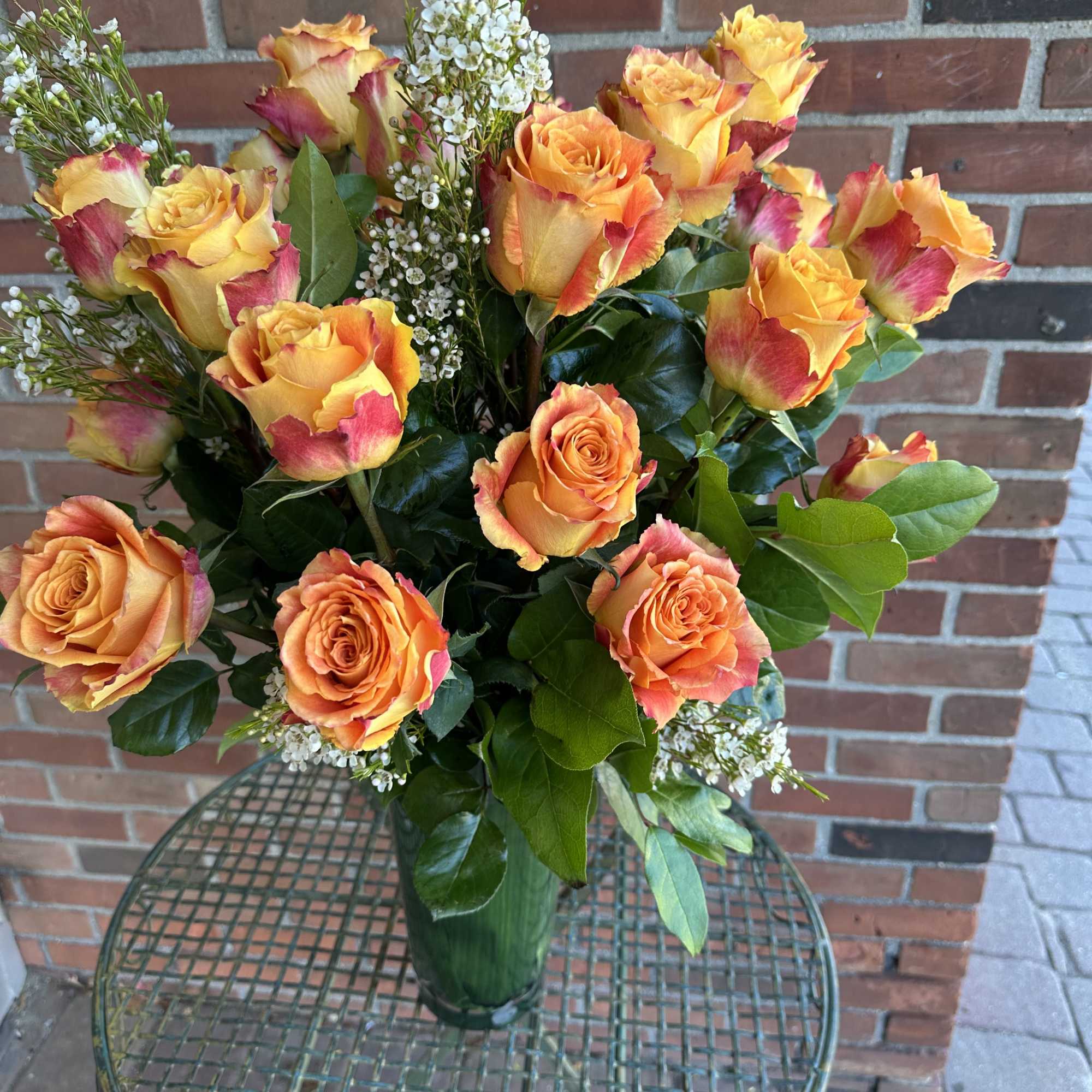 Deluxe orange roses in beautiful vases 
**Standard version** Dozen Long-stemmed roses 
**Deluxe