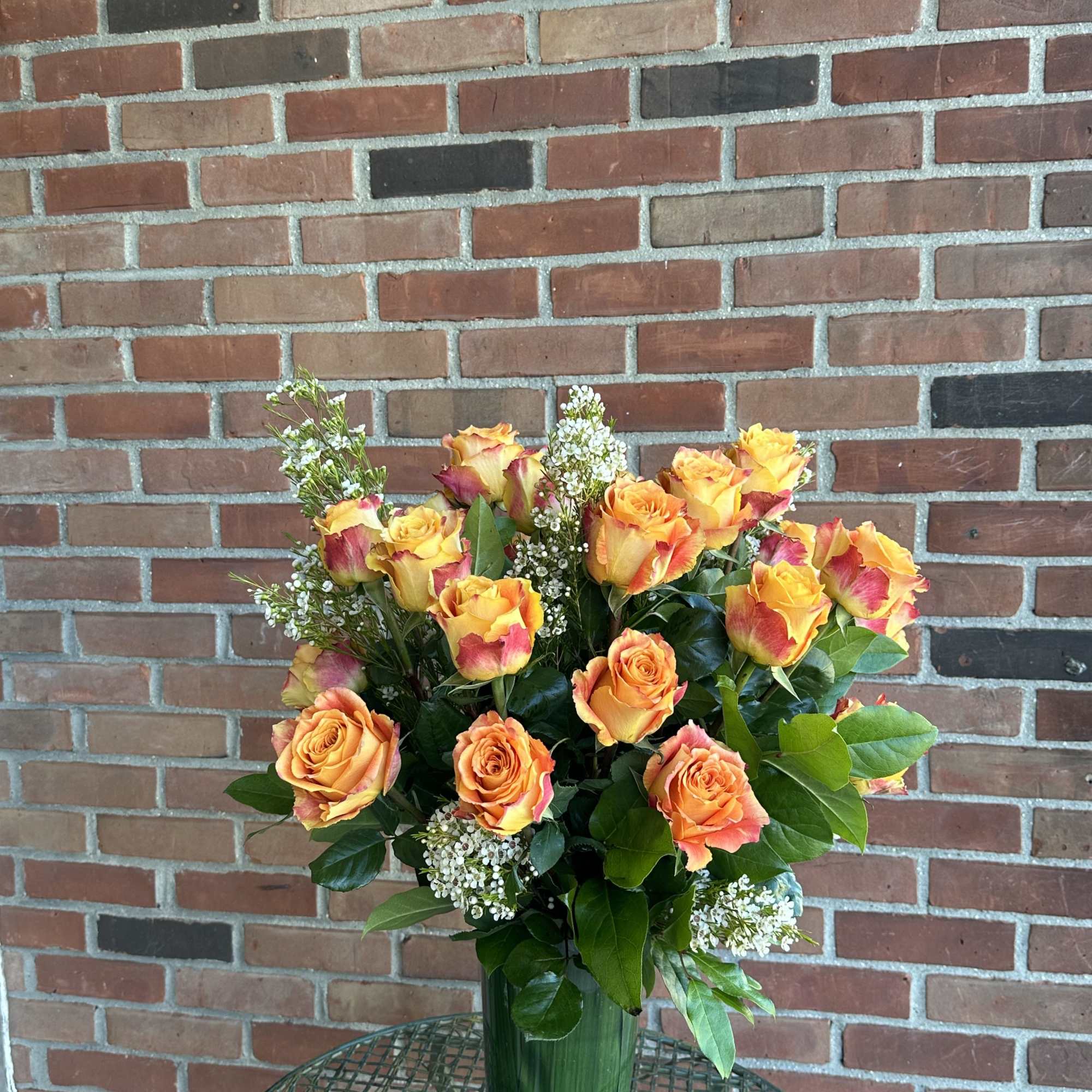 Deluxe orange roses in beautiful vases 
**Standard version** Dozen Long-stemmed roses 
**Deluxe