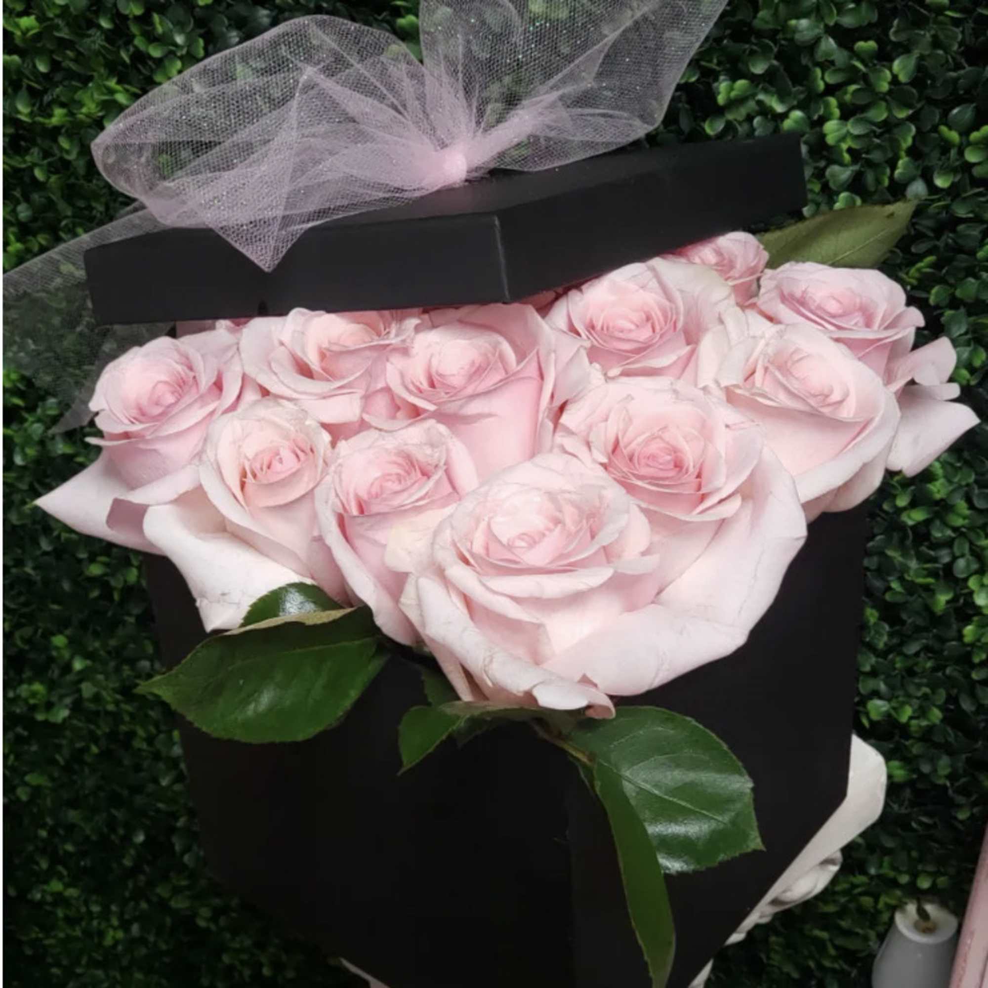 12 (standard) or 24 Deluxe  Pink Roses placed in a decorative