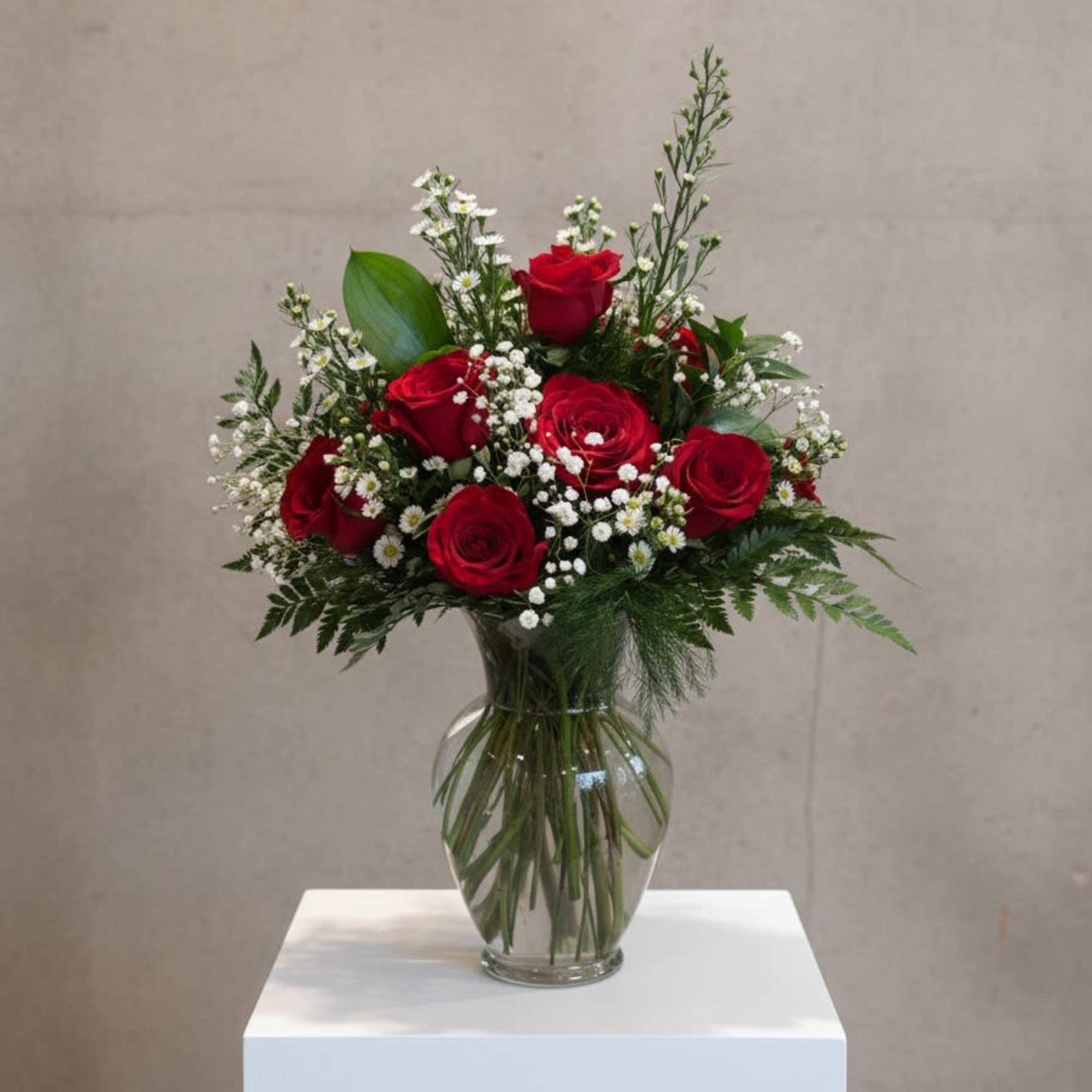 Elegant, romantic, and forever in style, this Classic Dozen Rose Arrangement features