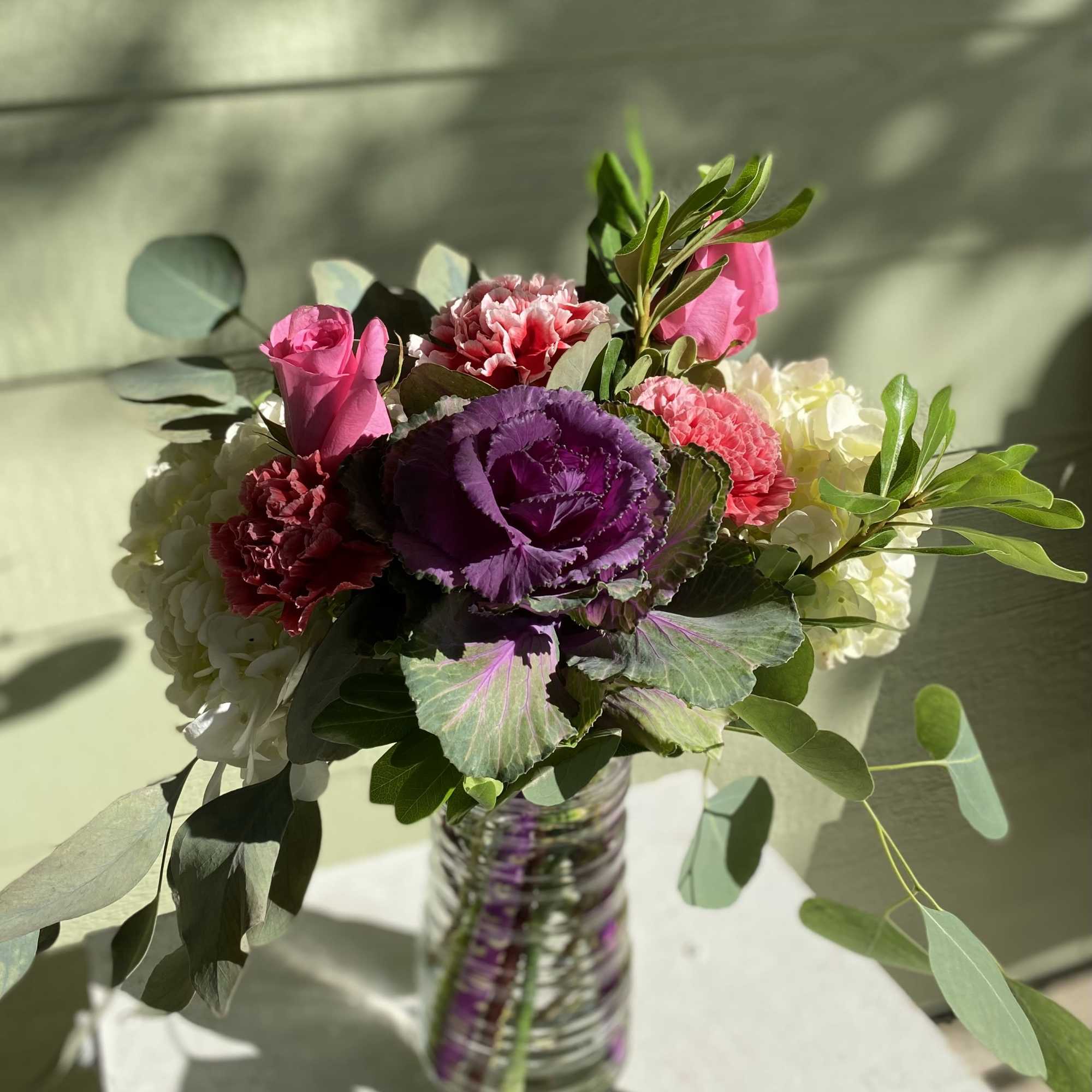 This flow he upscale design showcases giant blooms of kale and hydrangea