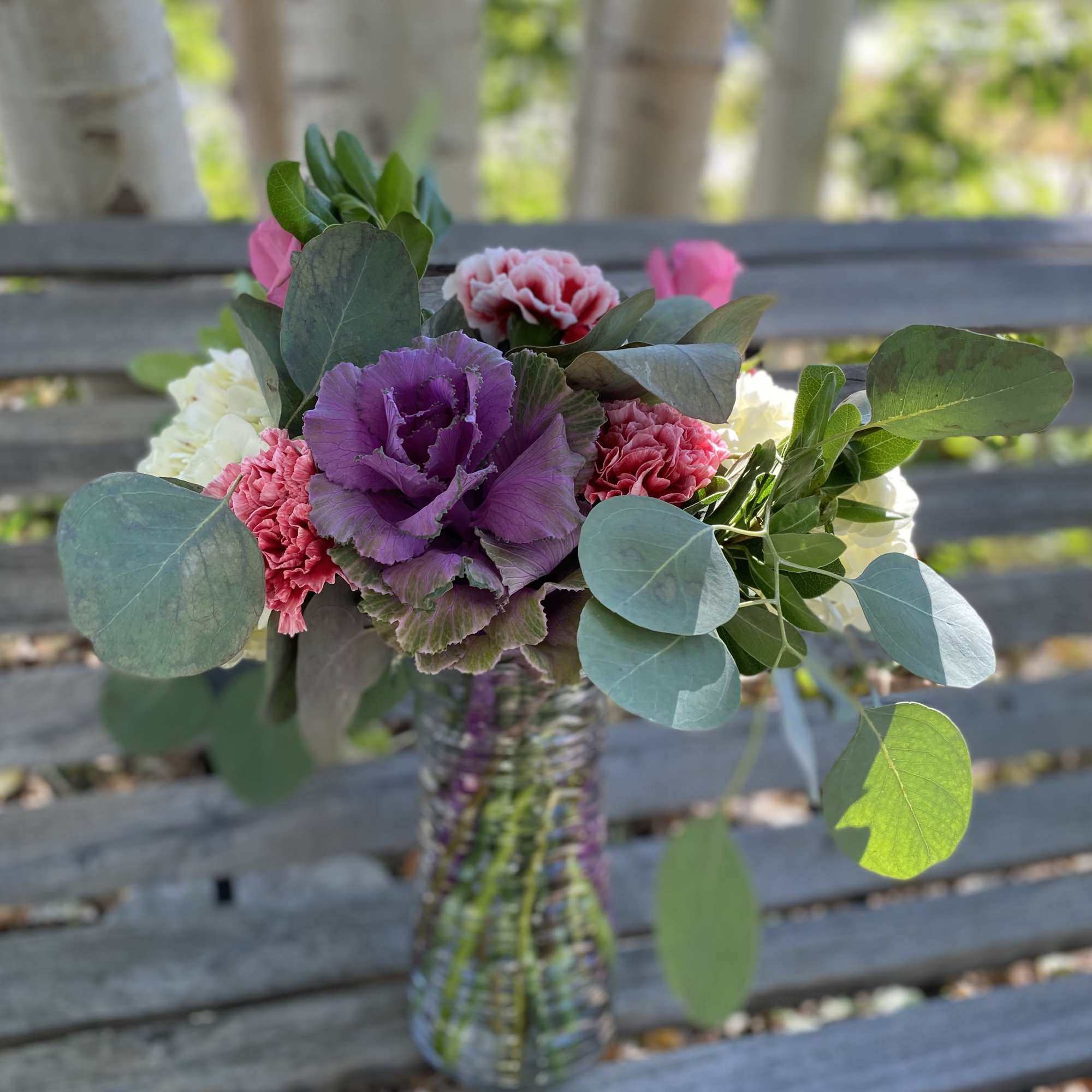 This flow he upscale design showcases giant blooms of kale and hydrangea